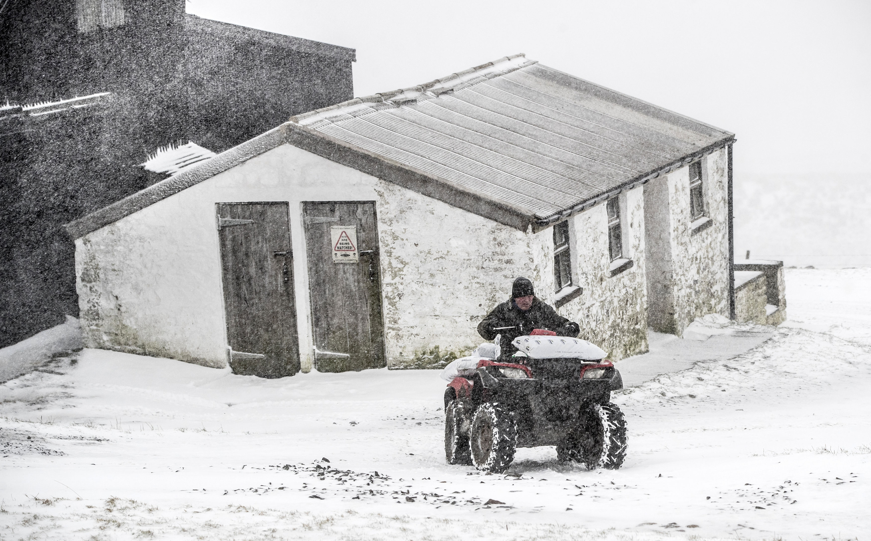 A farmer in a blizzard in Langdon Beck (Danny Lawson/PA)