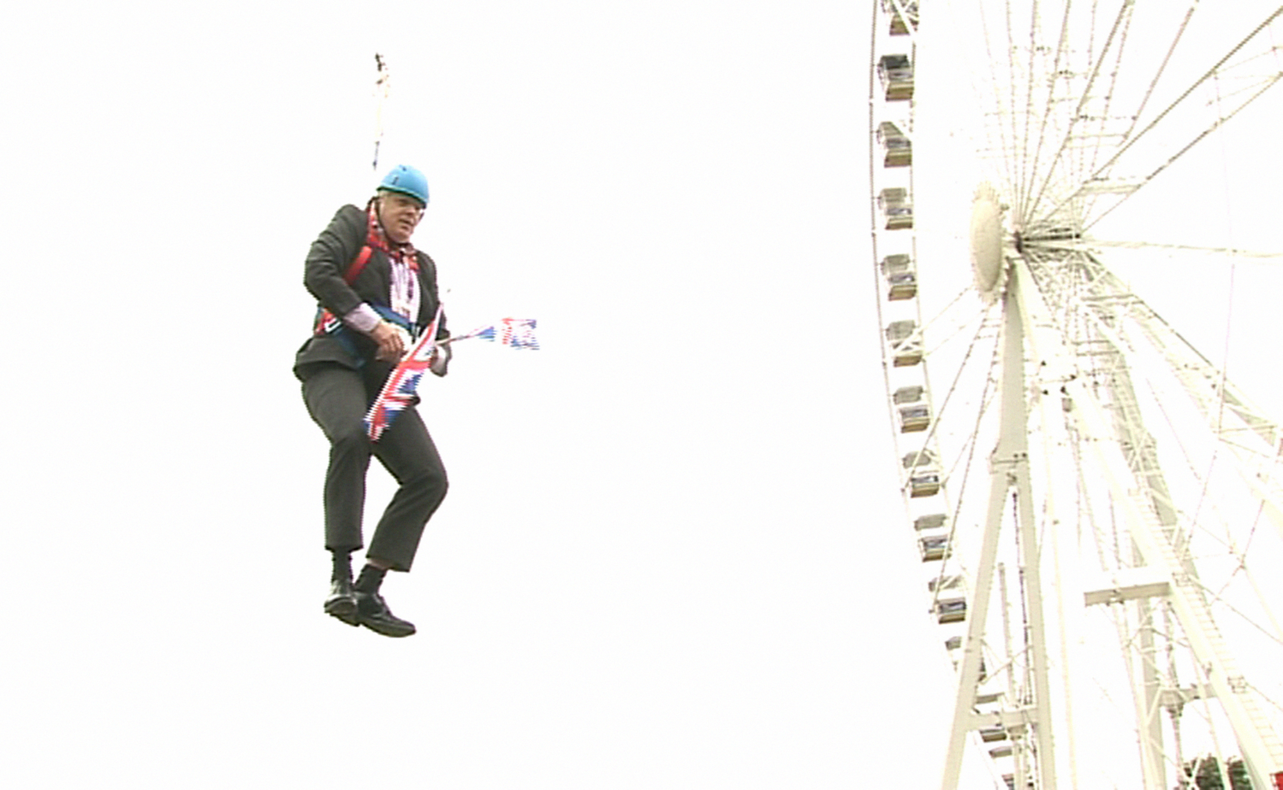 Former London Mayor Boris Johnson as he is left hanging in mid-air after he got stuck on a zipwire at an Olympic event at Victoria Park in London