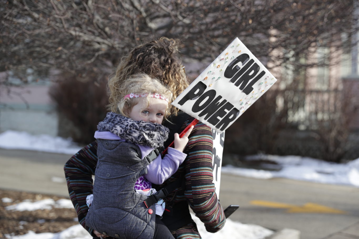 Peighton Letizia, 3, holds a "girl power" sign during a march in Wisconsin, US (Sarah Kloepping/AP)