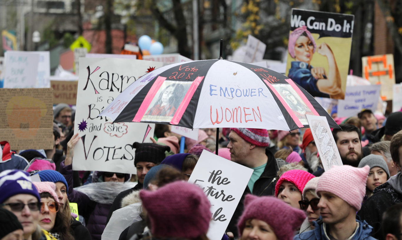 An umbrella reads "Empower Women" in Seattle on Saturday (Ted S. Warren/AP)
