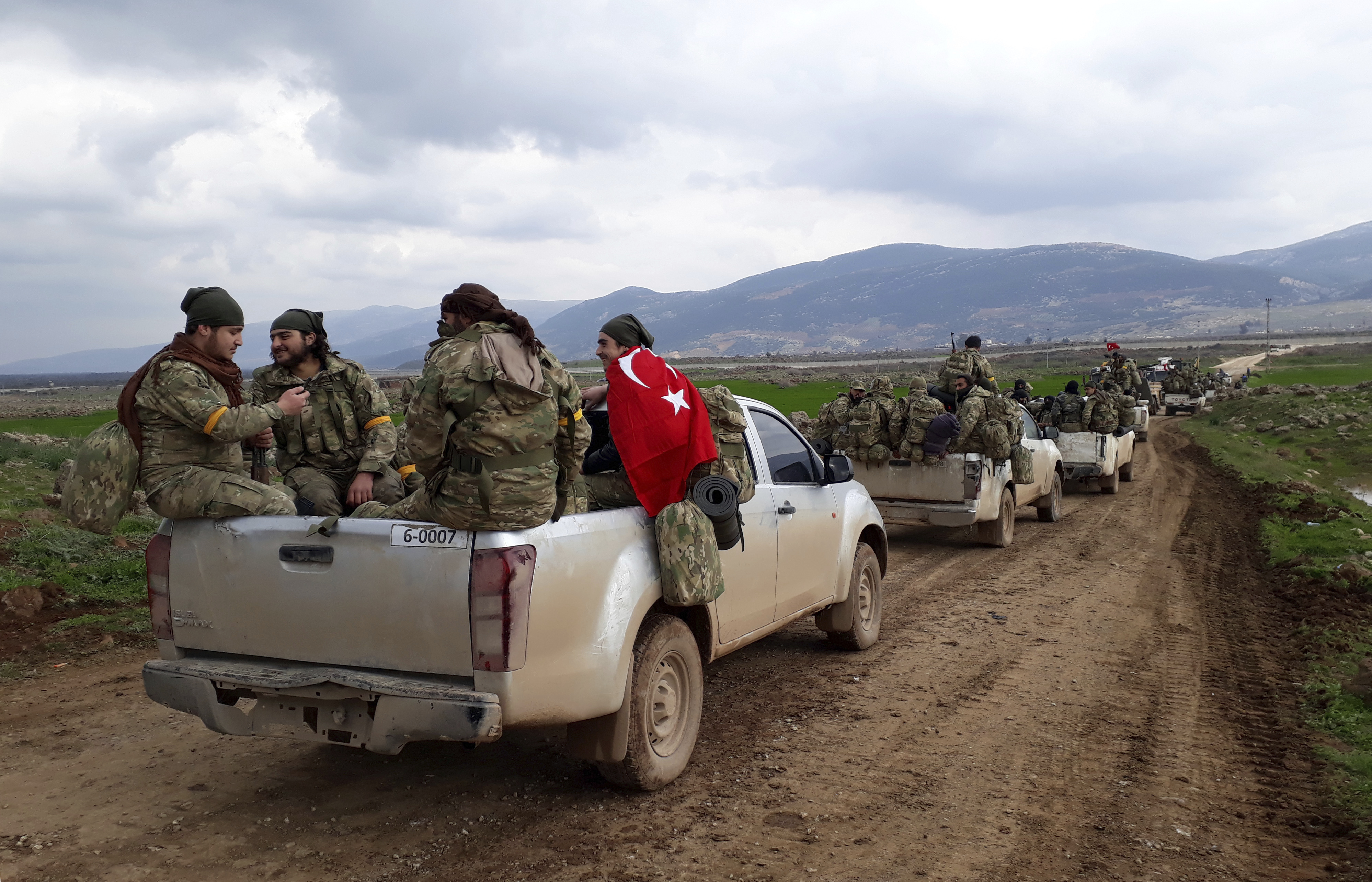 Turkey-backed Free Syrian Army fighters head towards the Syrian border in Kirikhan, Turkey (Furkan Arslanoglu/Depo Photos via AP)