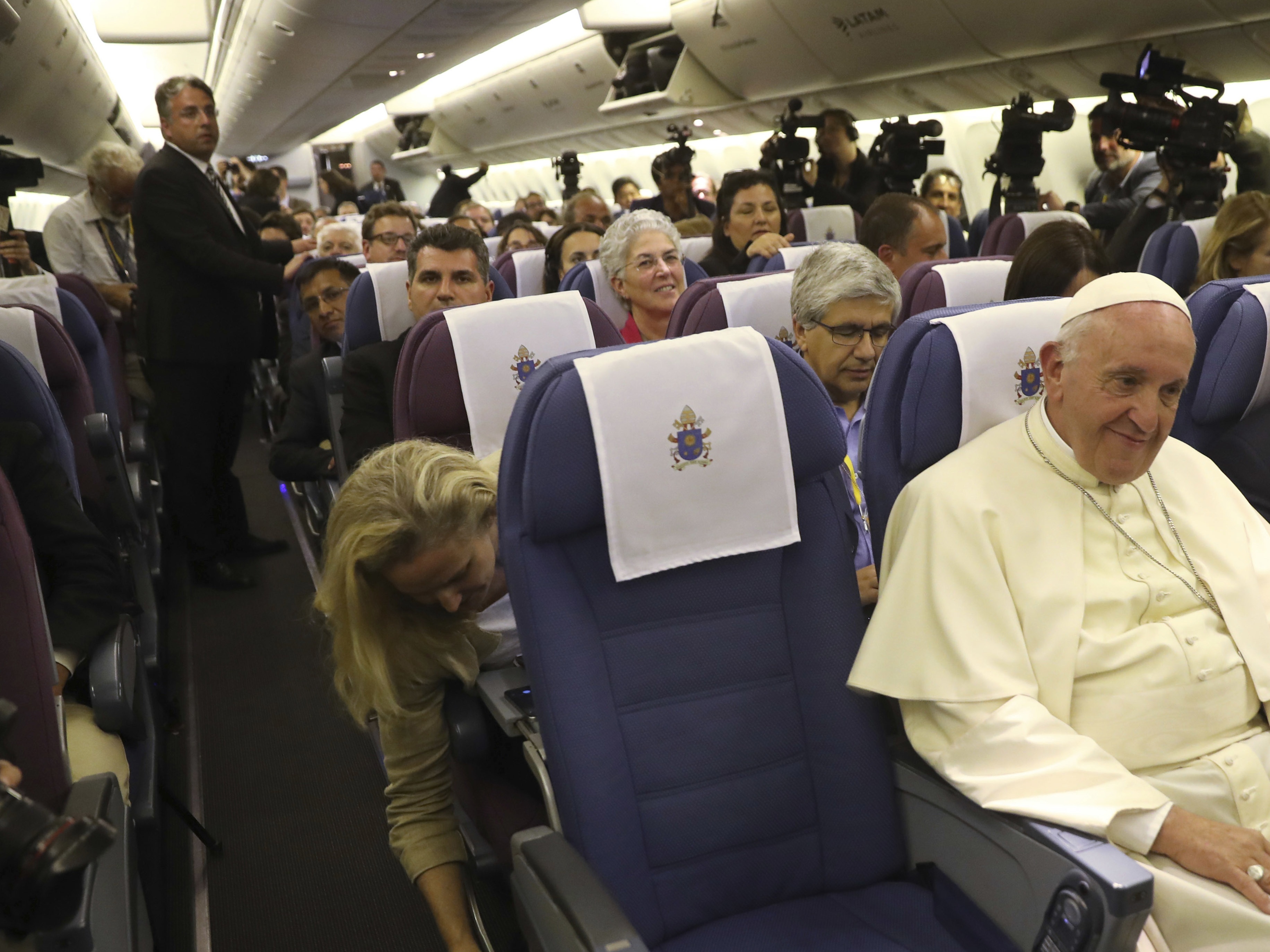 Pope Francis sitting with journalists during some mid-flight turbulence (Alessandra Tarantino/AP)