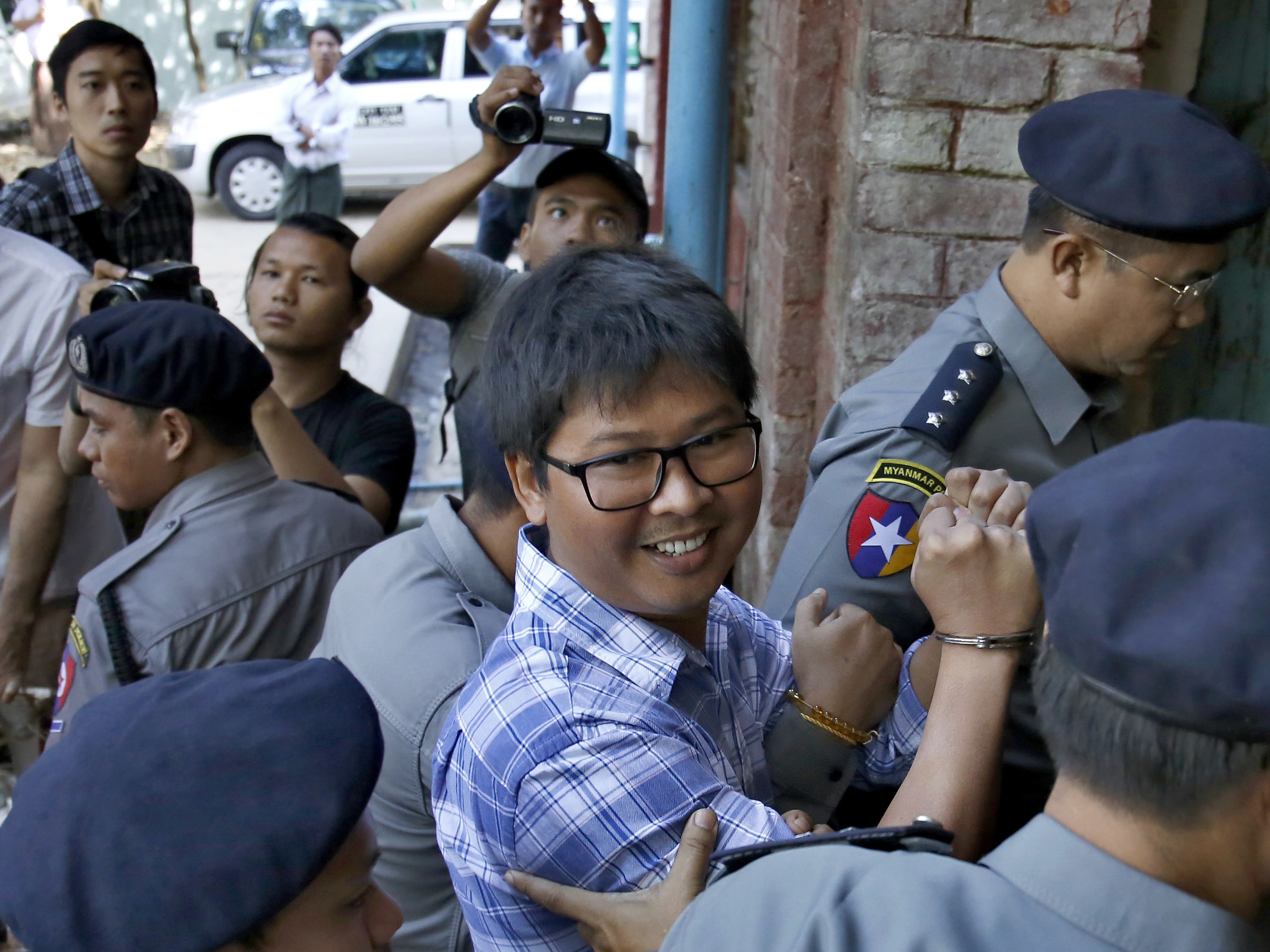 Wa Lone smiles as he is escorted into court (Lamin Tun/AP)