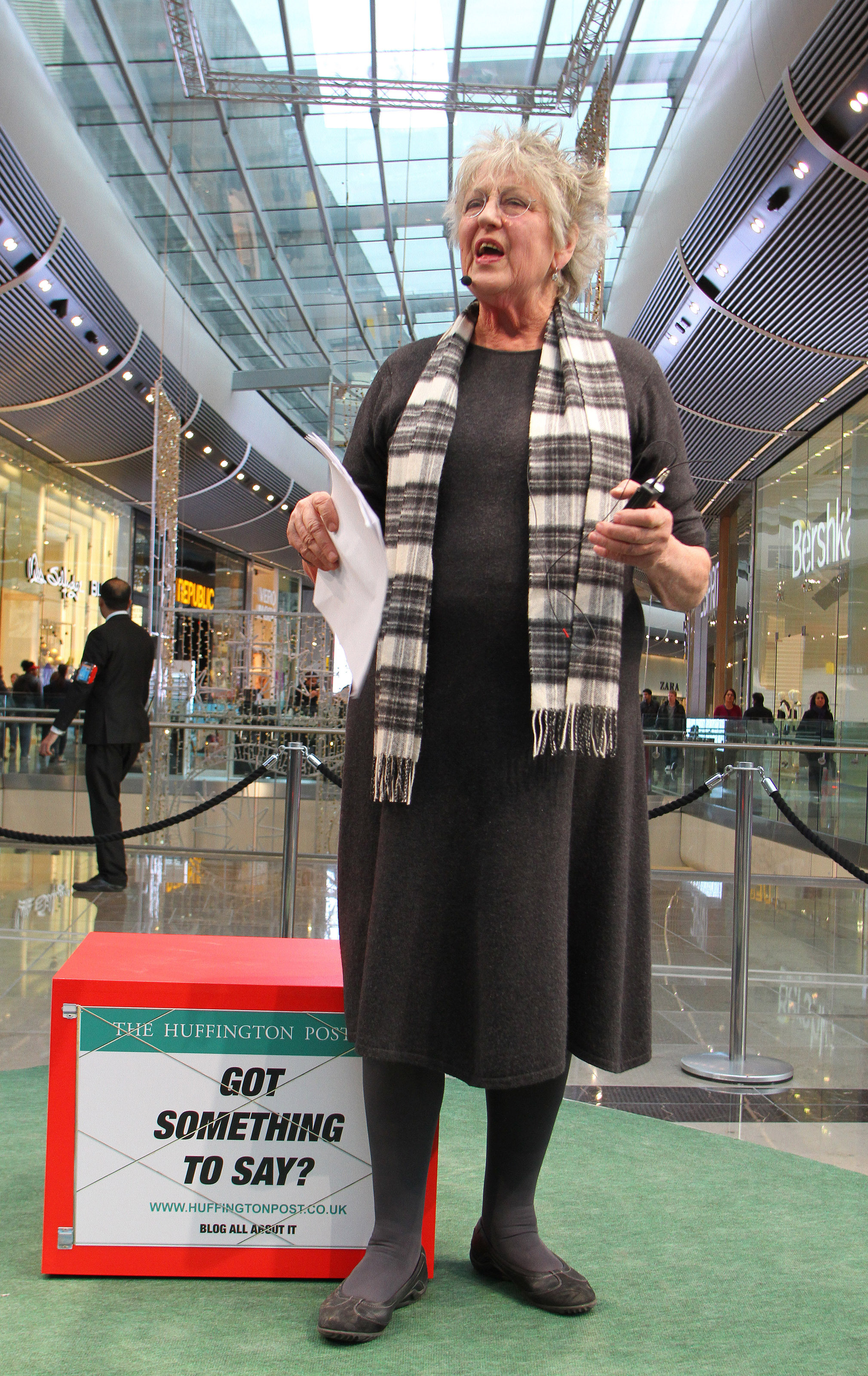 Germaine Greer speaking in a shipping centre