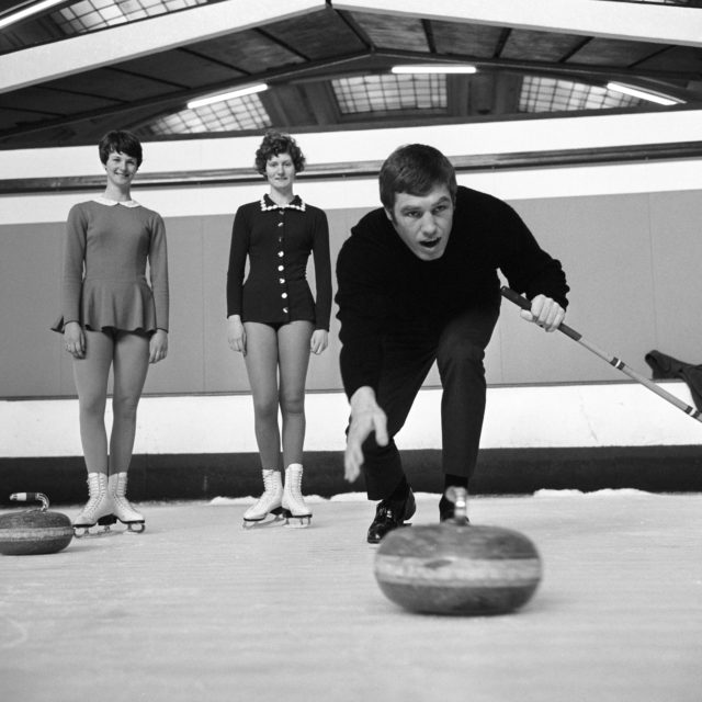 Boxer Billy Walker training for a fight with Ray Patterson in 1955 by testing his hand at curling (PA)