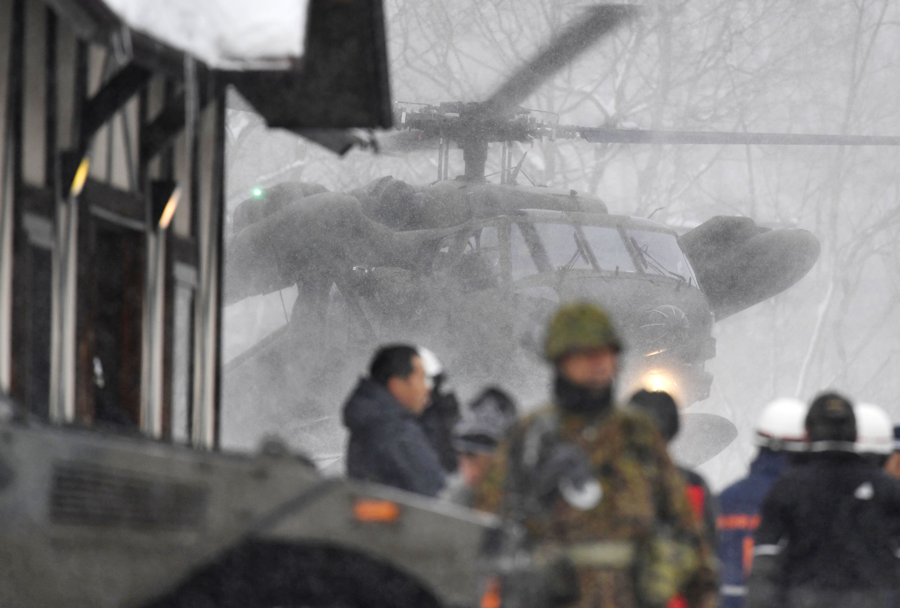 A helicopter takes part in the rescue operation (Muneyuki Tomari/AP)