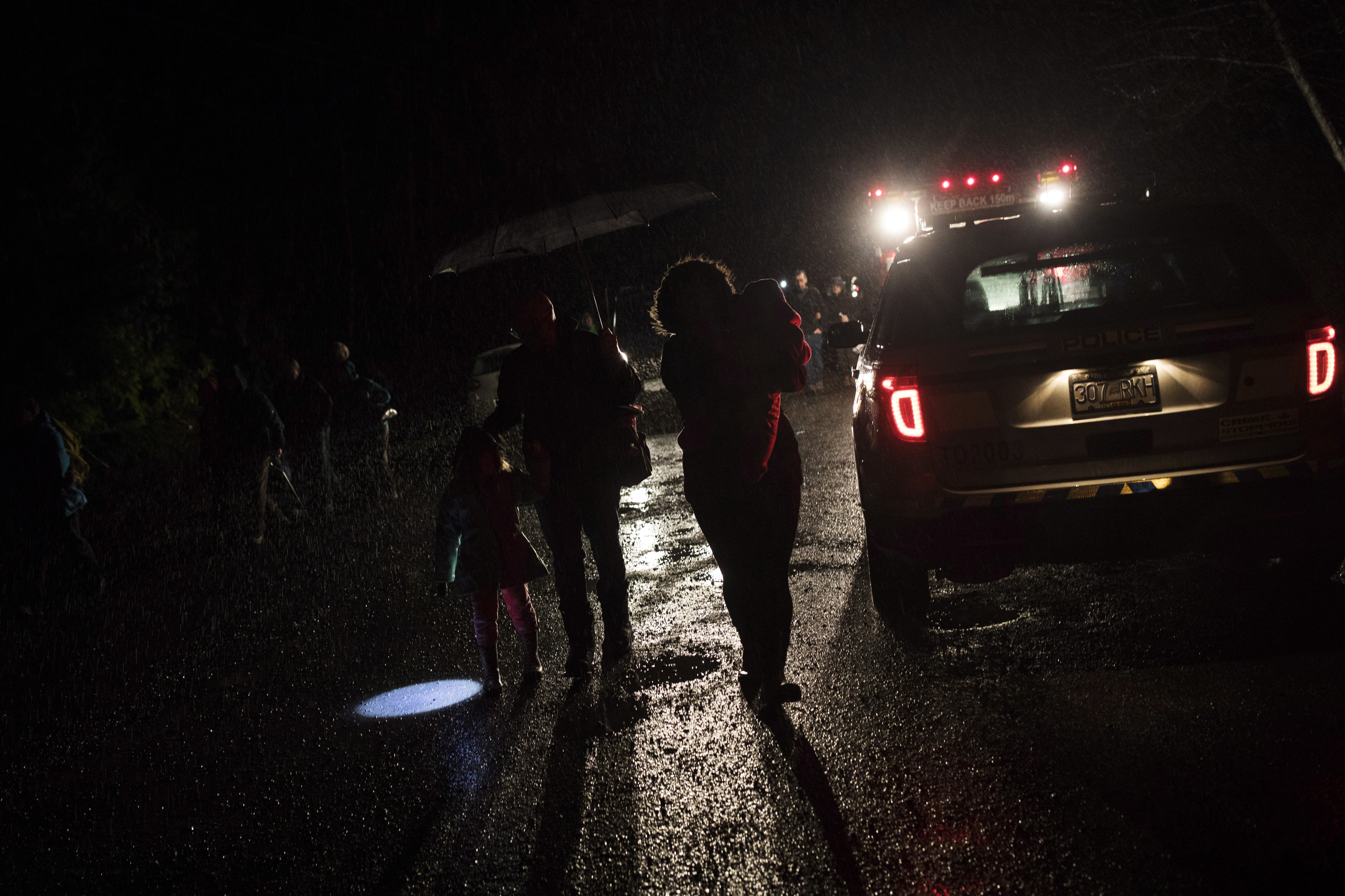 Tofino residents and visitors leave the community center after the tsunami warning ends, in Tofino, British Columbia