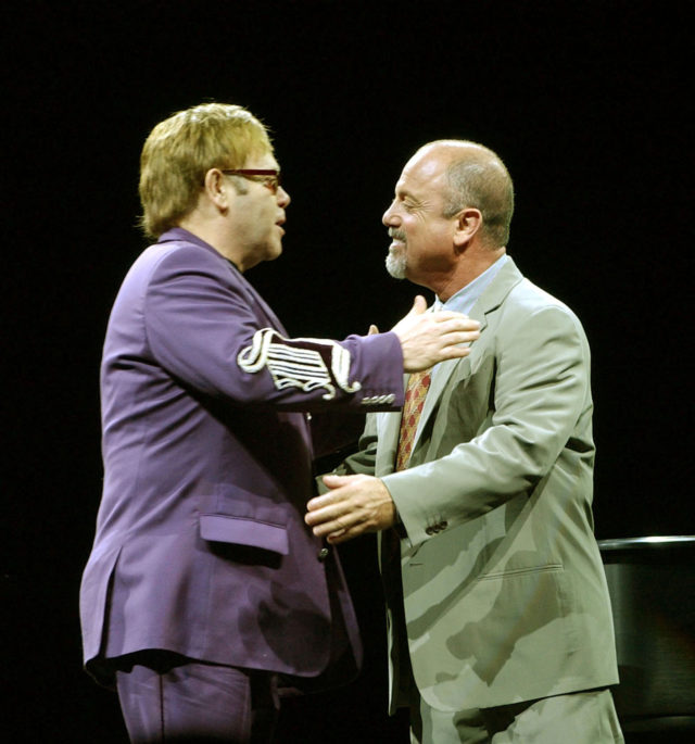 Elton John and Billy Joel embrace before the start of their Face to Face concert at Madison Square Gardens in 2002 (PA)
