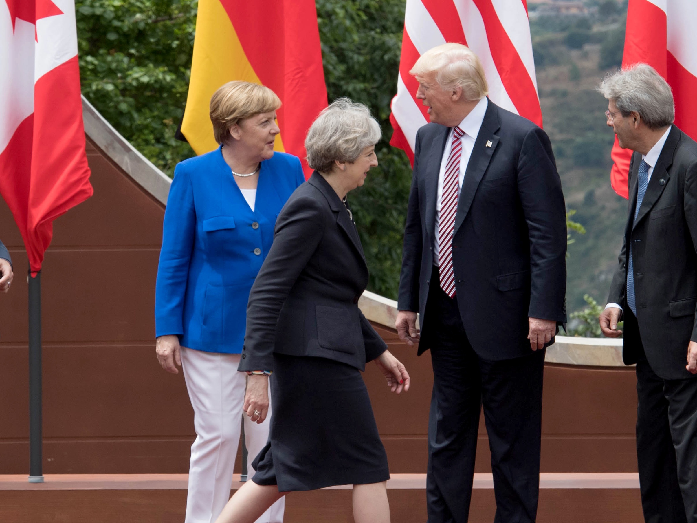 Theresa May walks past Donald Trump during the G7 summit in Taormina, Italy (Stefan Rousseau/PA)