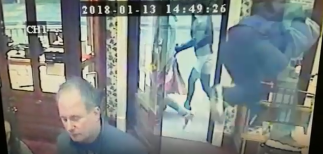 A thief jumps over the counter at DJM Goldsmiths jewellery store in Preston, Lancashire