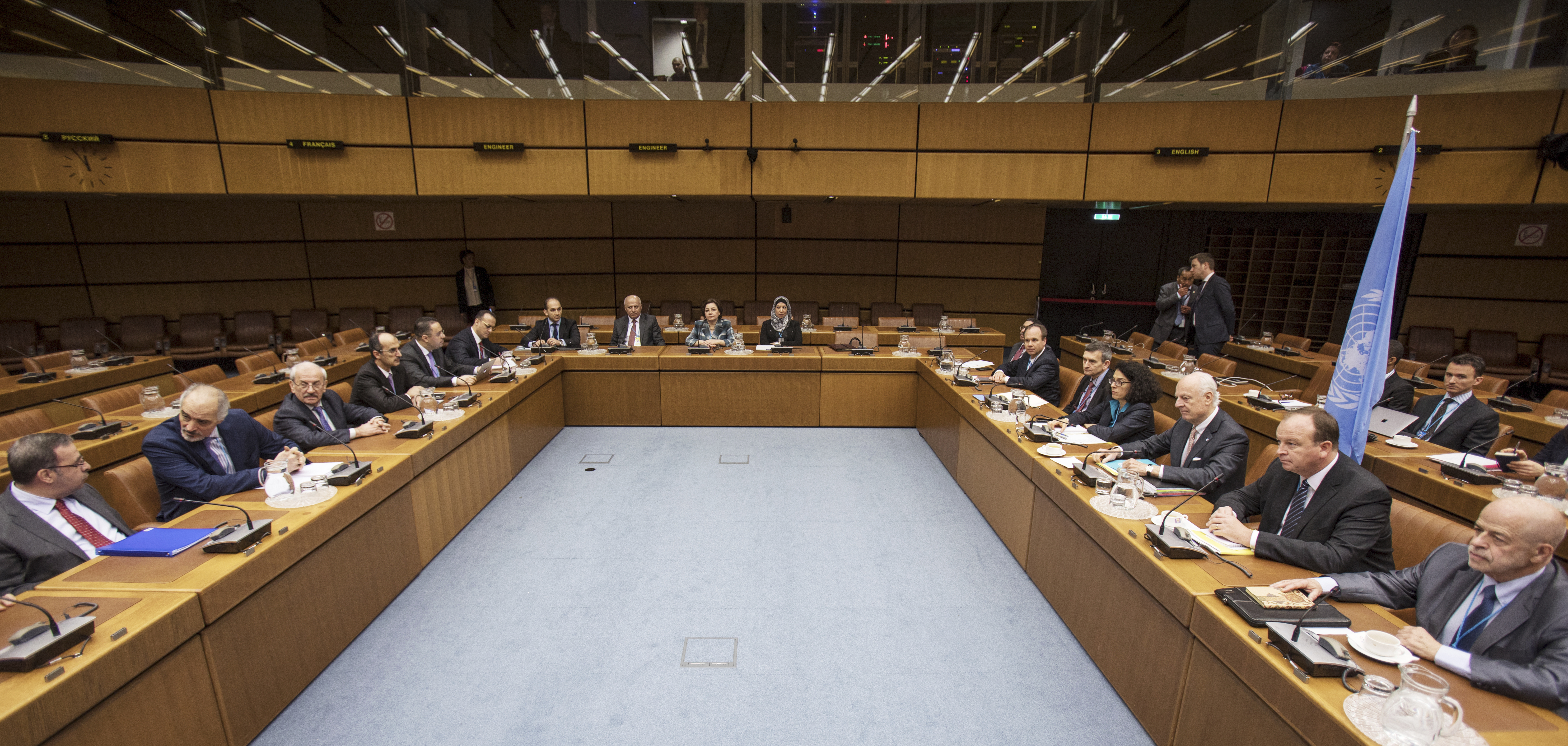 UN envoy Staffan de Mistura, third right, and Syrian chief negotiator and Ambassador of the Permanent Representative Mission of Syria to the United Nations Bashar al-Jaafari, second left, sit with other delegate members ahead of the start of official talks on Syria, in Vienna (Alex Halada/pool via AP)