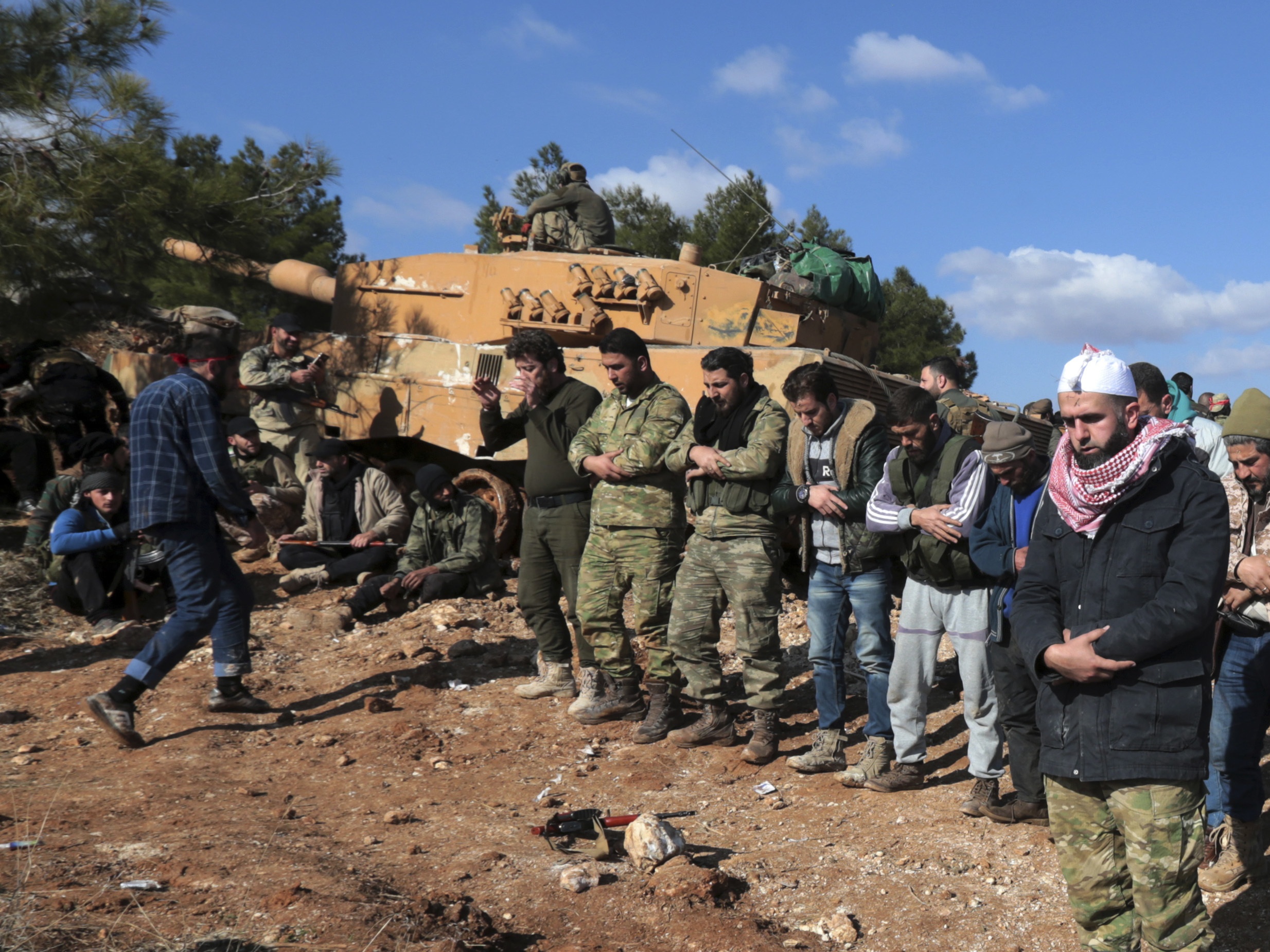 pro-turkey syrian fighters pray after capturing bursayah hill