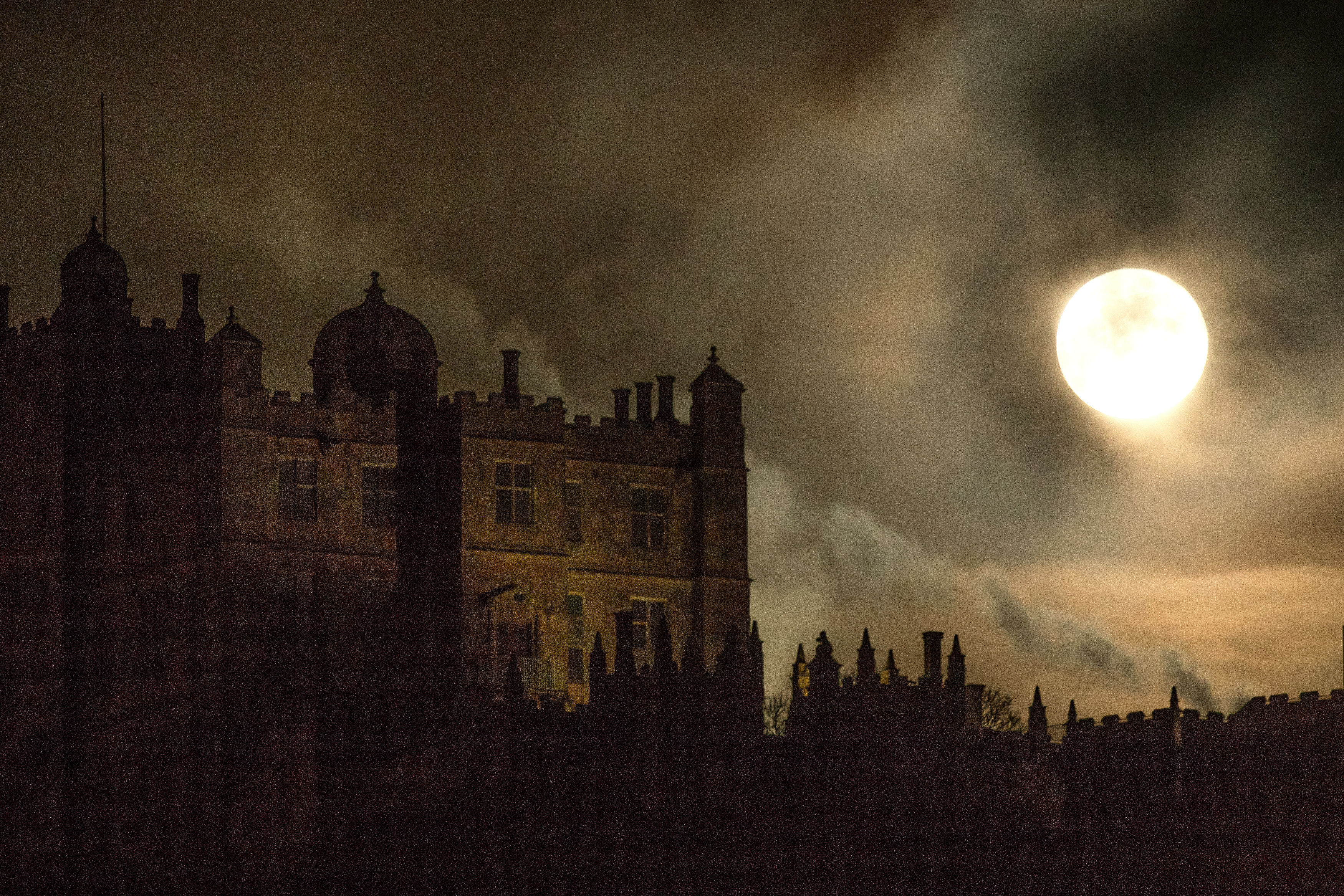 Incredibly bright moon above a stately home