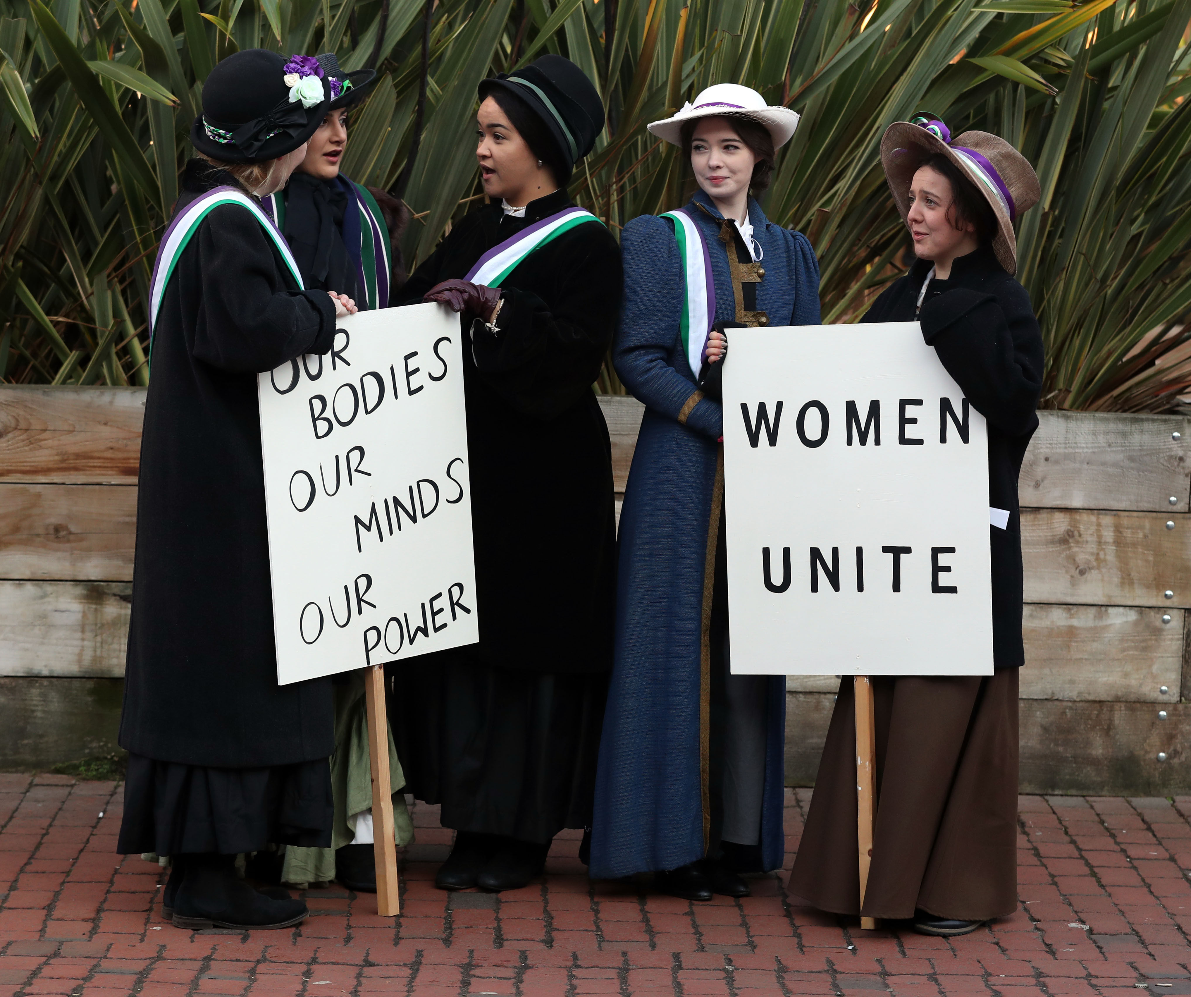 Students from Royal Holloway, University of London recreate a protest march by suffragettes (Steve Parsons/PA)