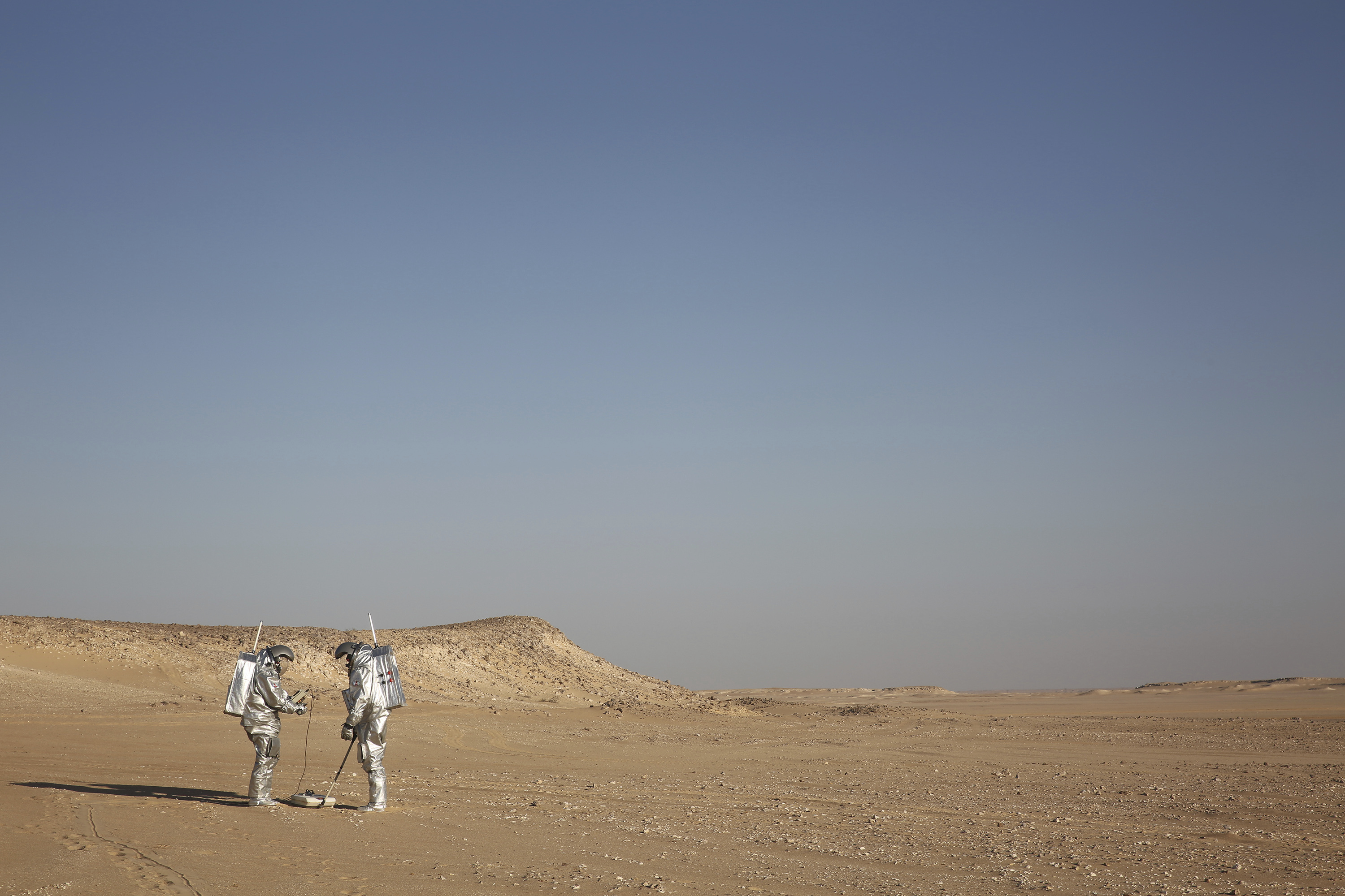 Two scientists test space suits and a geo-radar for use in a future Mars mission in the Dhofar desert of southern Oman (Sam McNeil/AP)