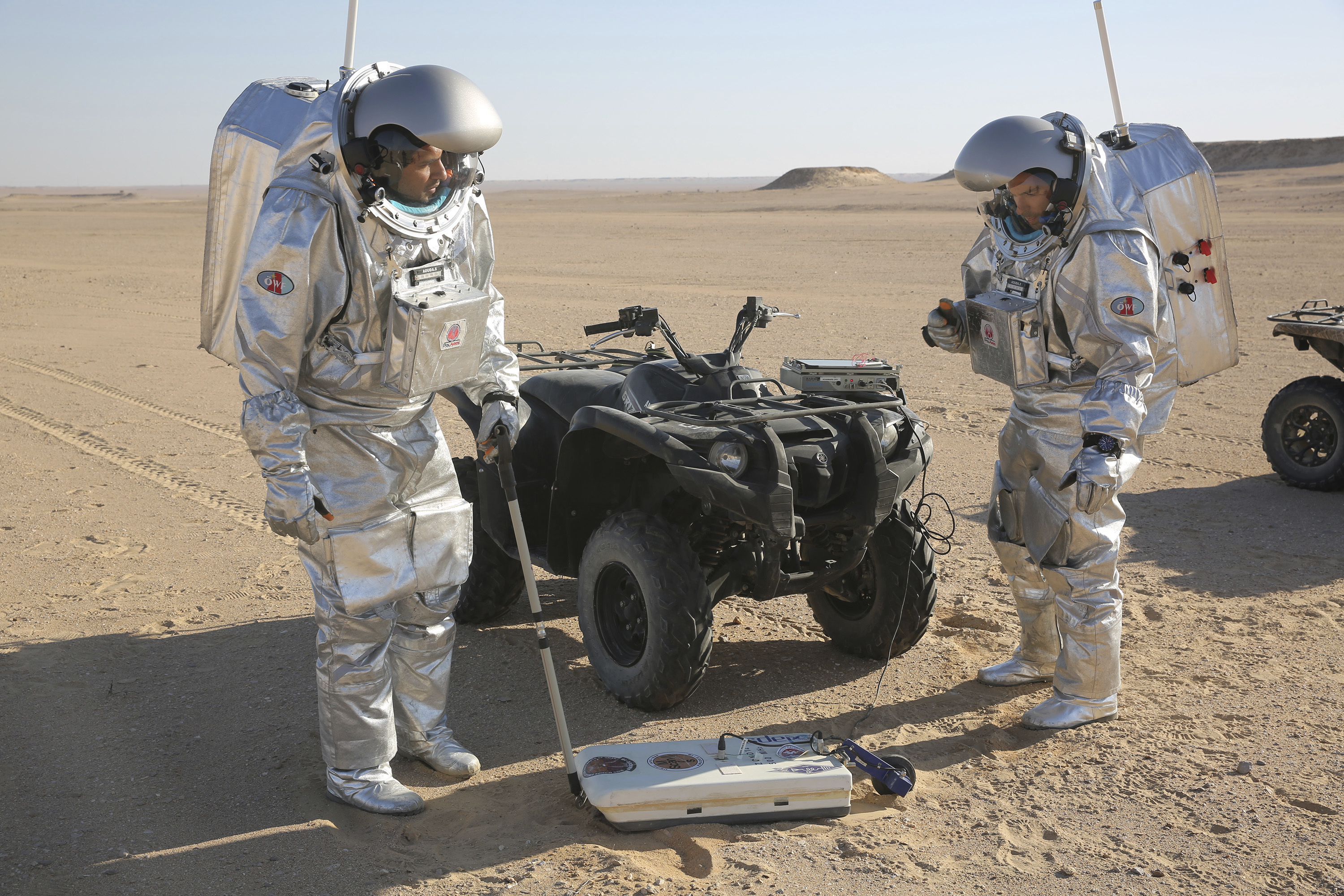 Two scientists test space suits and a geo-radar for use in a future Mars mission in the Dhofar desert of southern Oman (Sam McNeil/AP)