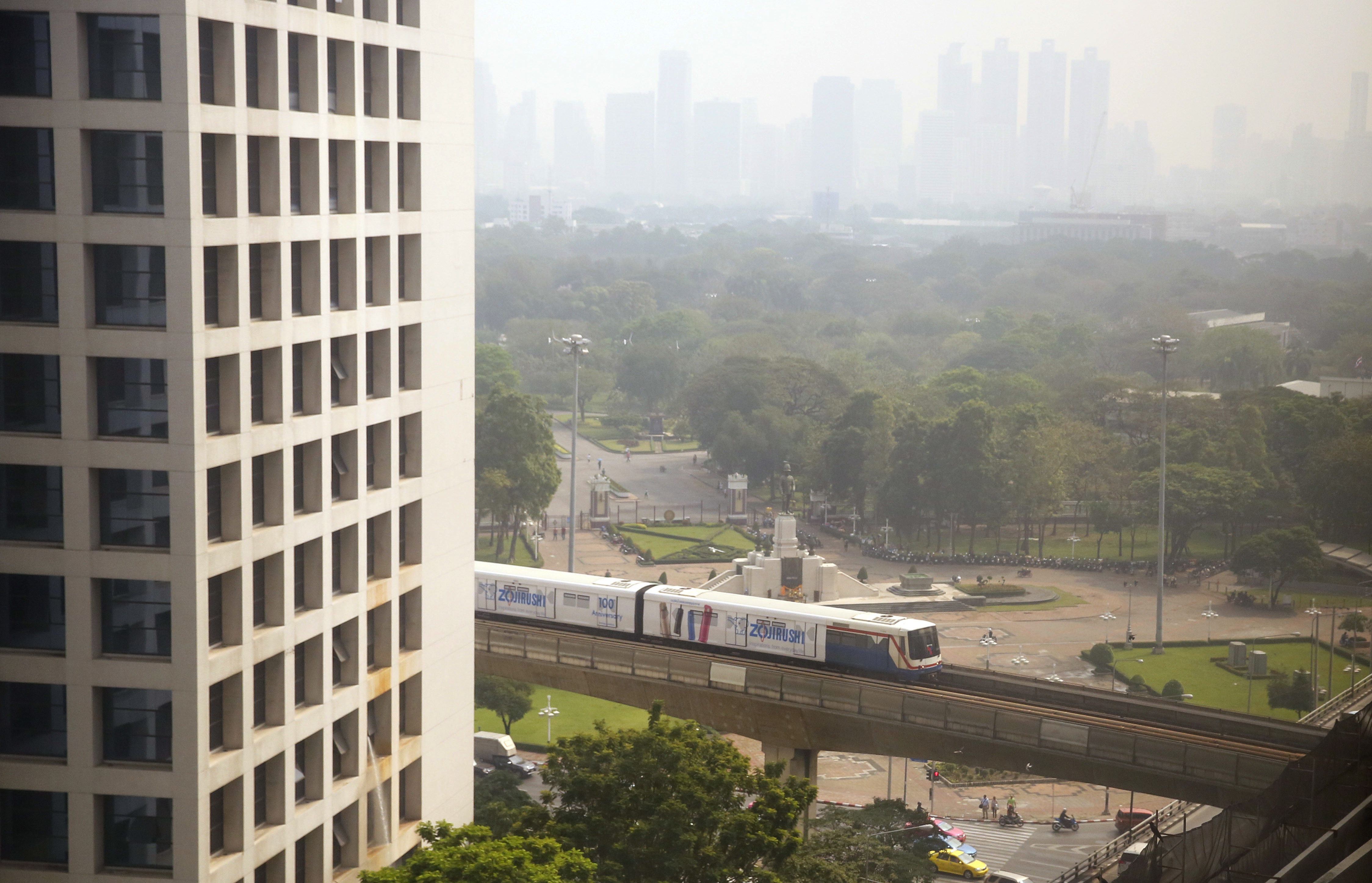 The elevated train passes in front of Lumpini Park covered in a thick layer of smog in Bangkok (AP)