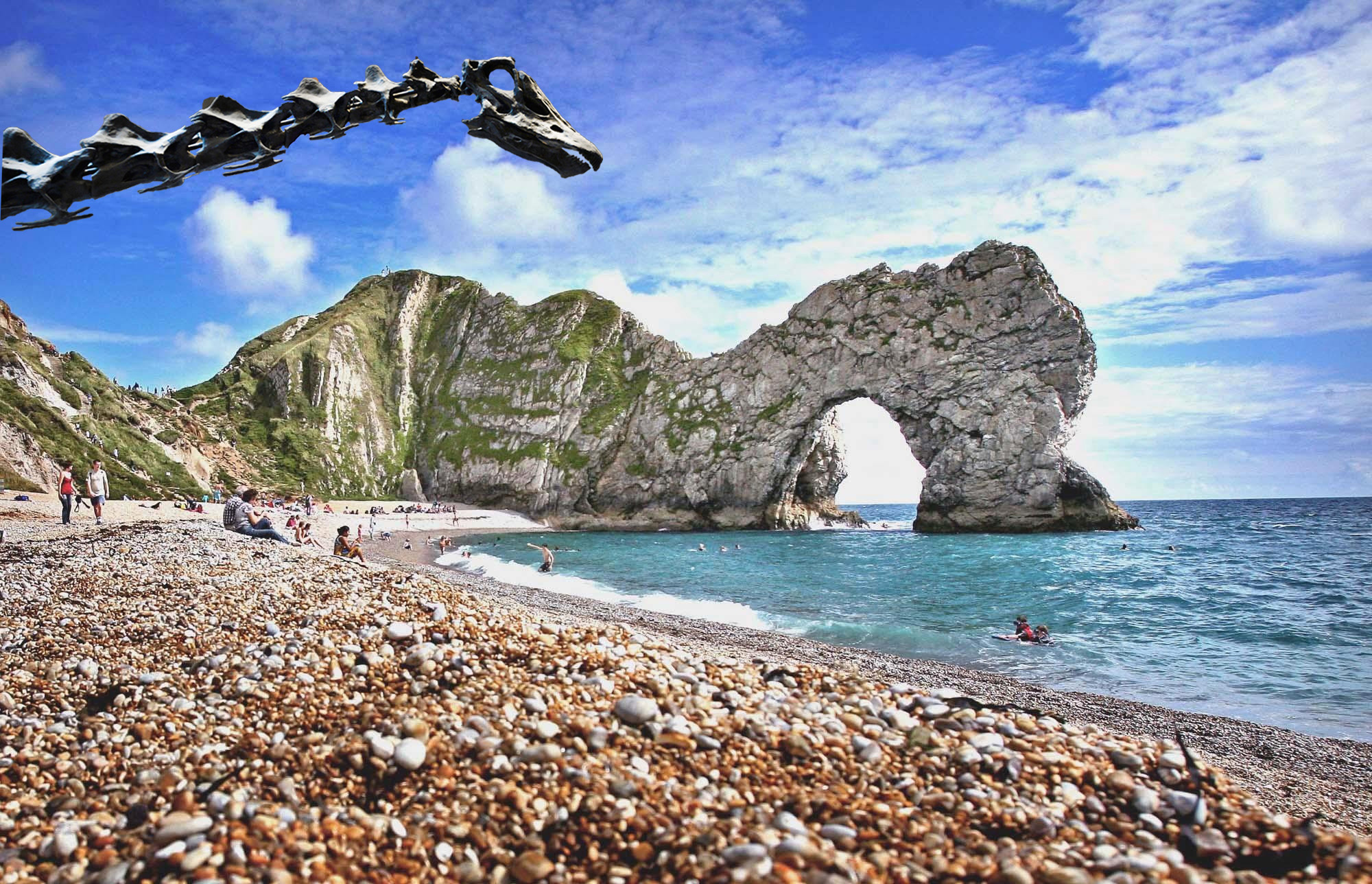 Two men jump off rocks into the sea at Durdle Door near West Lulworth, Dorset