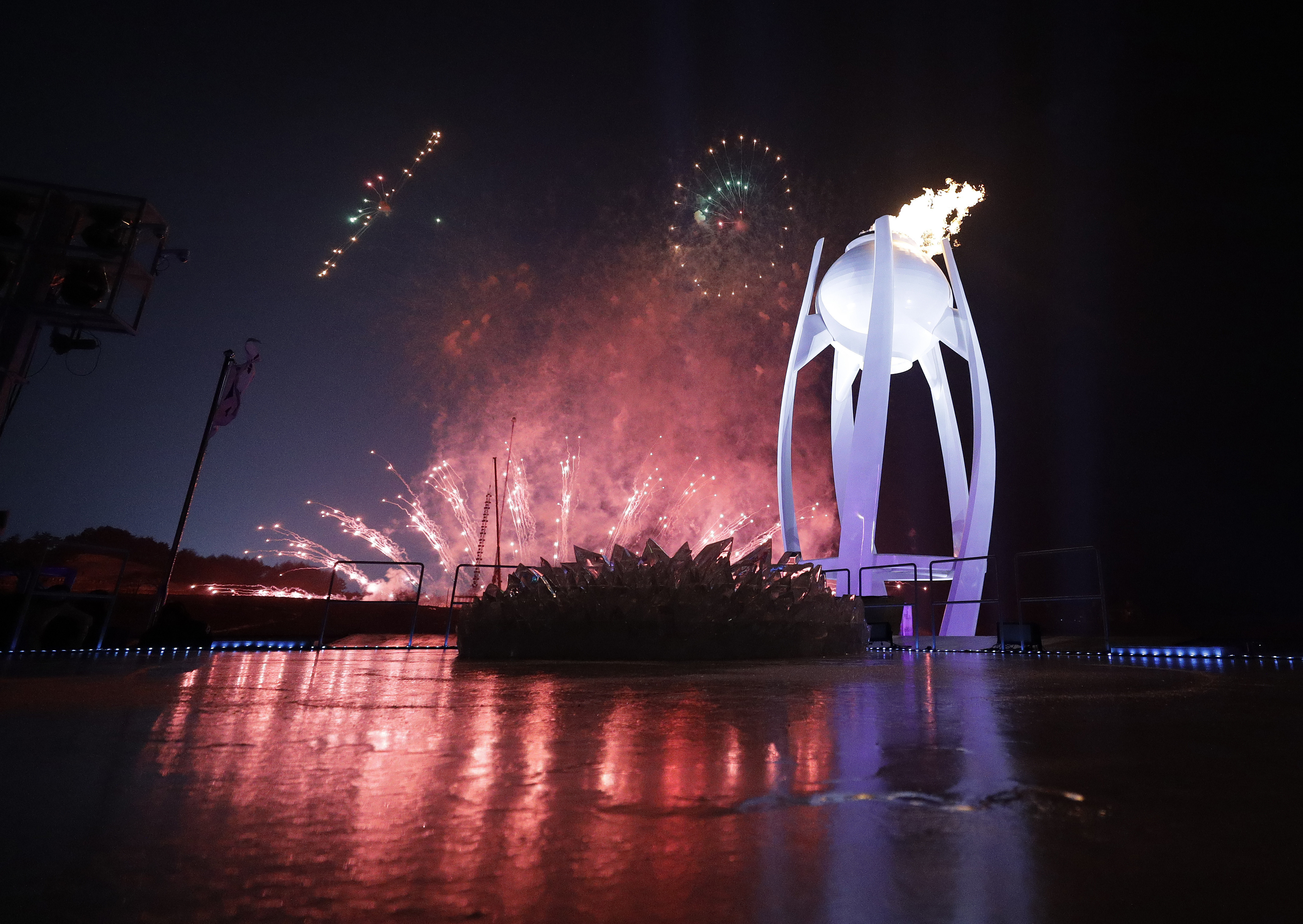 Fireworks behind the Olympic flame during the opening ceremony of the 2018 Winter Olympics at Pyeongchang