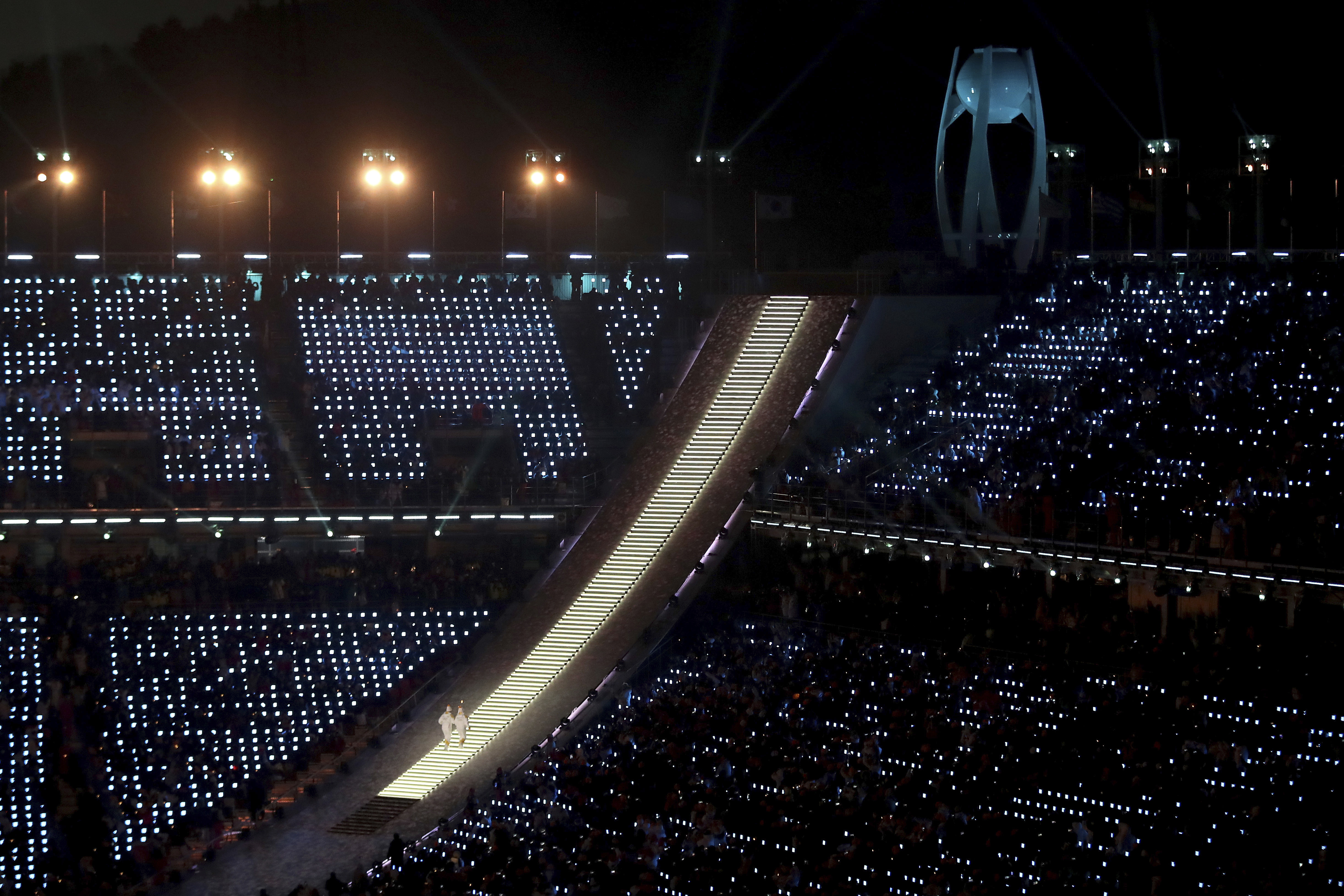 The Olympic torch bearers ascend to light the cauldron during the opening ceremony of the 2018 Winter Olympics in Pyeongchang