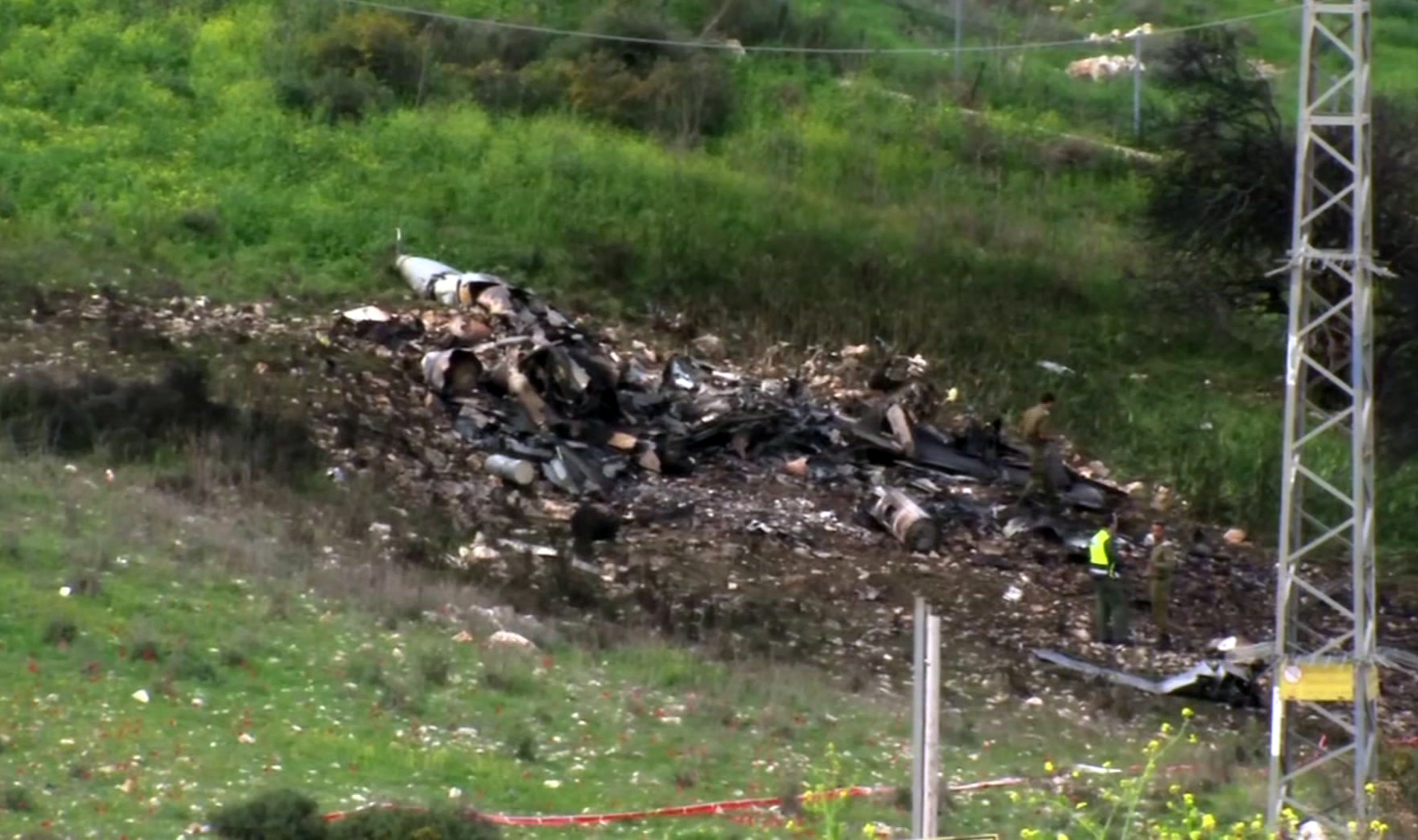 In this image made from video, the wreckage of a jet is seen near Harduf, northern Israel (Yehunda Pinto via AP)