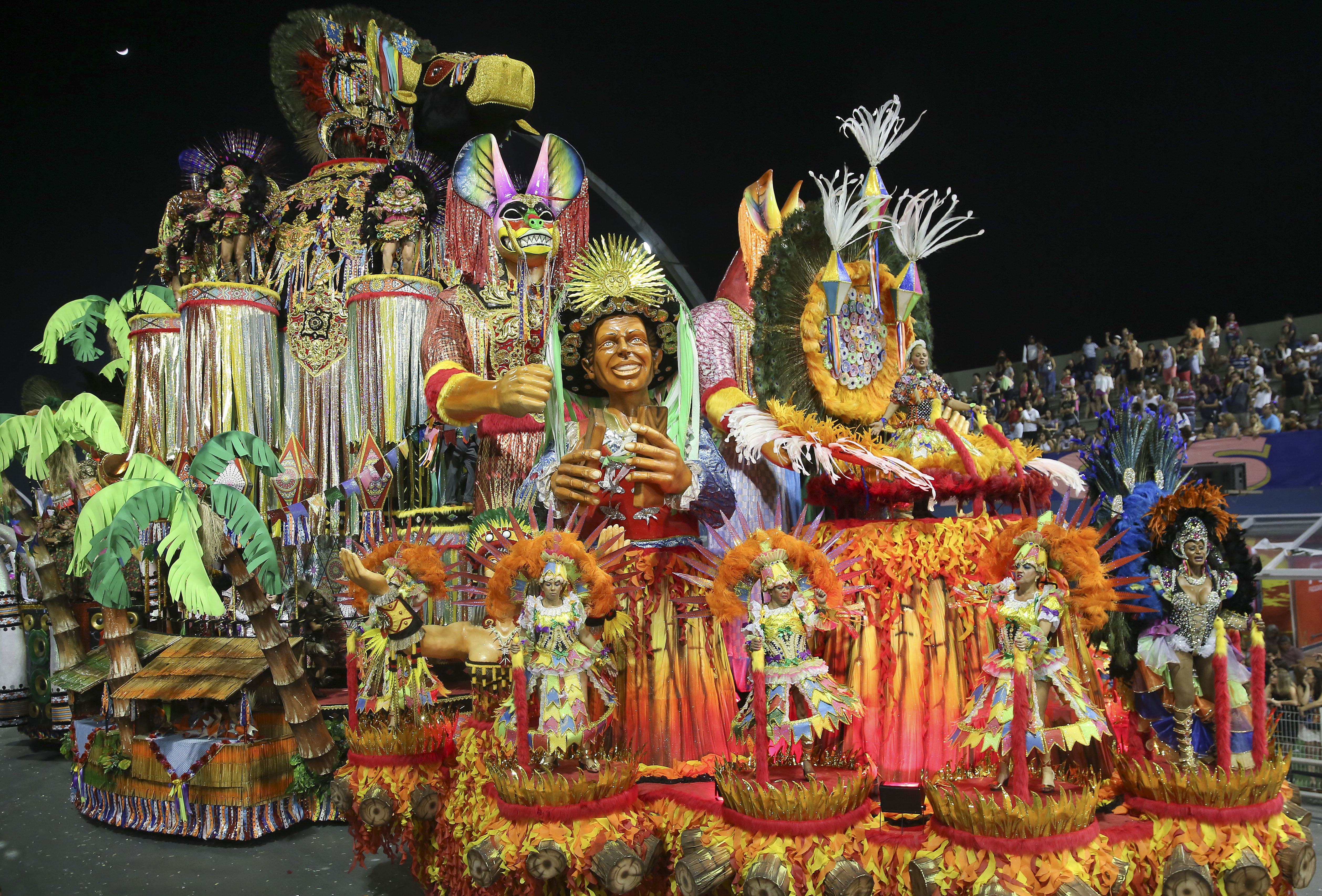 Dancers from the Academicos do Tatuape samba school perform on a float during a carnival parade in Sao Paulo (Andre Penner/AP)