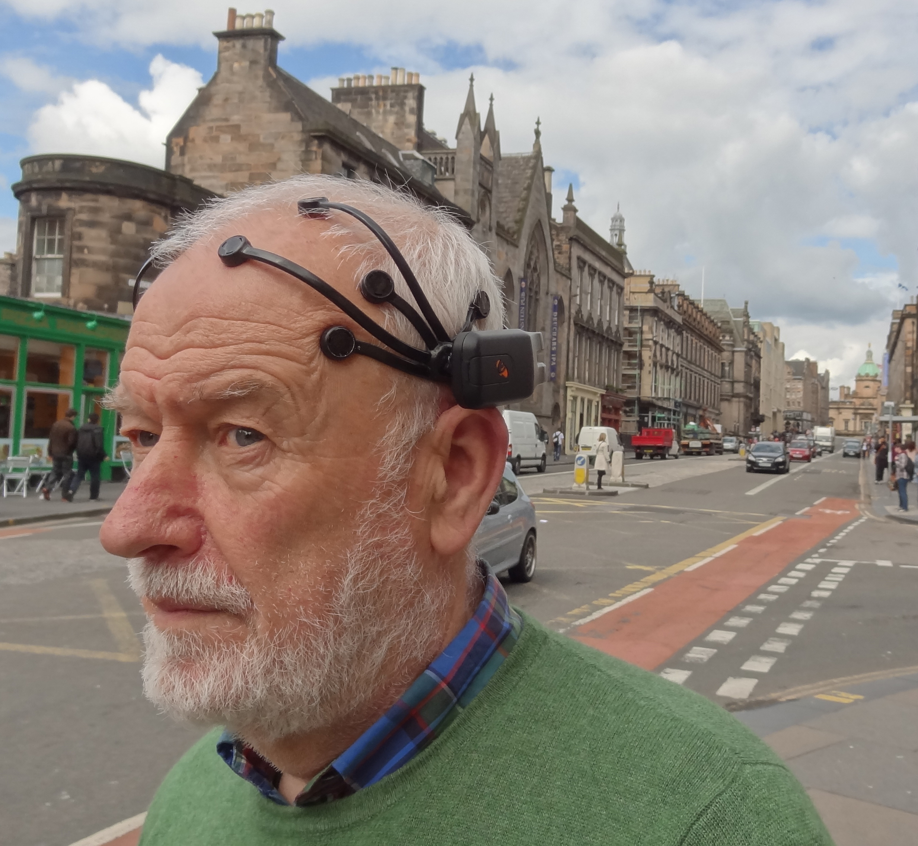  A man wearing an EEG headset.