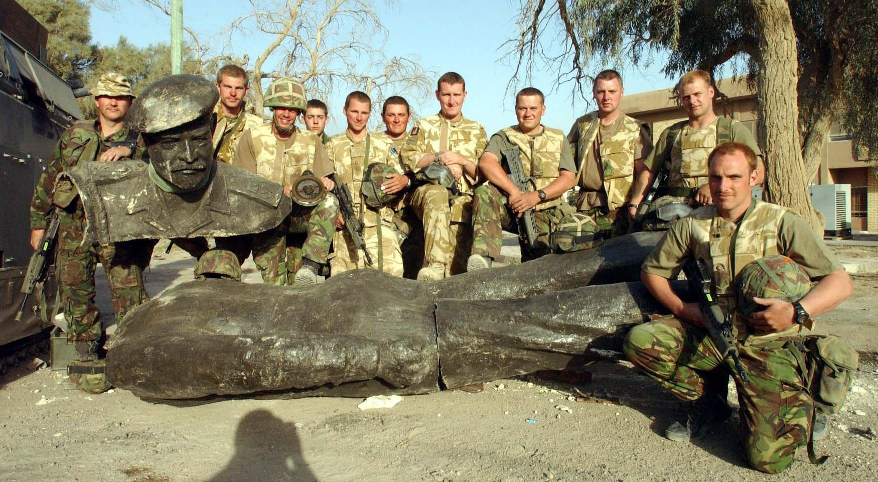 British troops with a toppled statue of former Iraq president Saddam Hussein (PA)