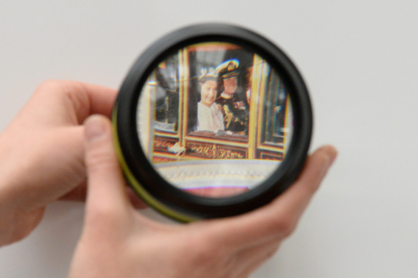A visitor looks at a Silver Jubilee stamp through a magnifying glass (Kirsty O'Connor/PA)