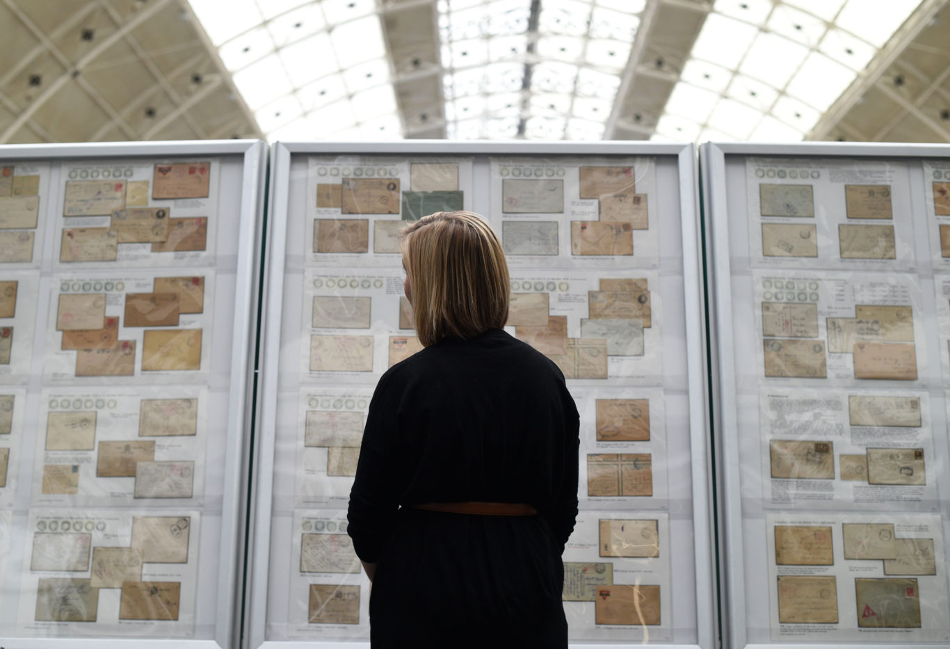 A visitor looks at a collection of envelopes and stamps during the Stampex philatelic exhibition (Kirsty O'Connor/PA)