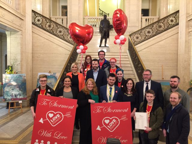 SDLP leader Colum Eastwood receives a giant Valentine's Day card (David Young/PA)