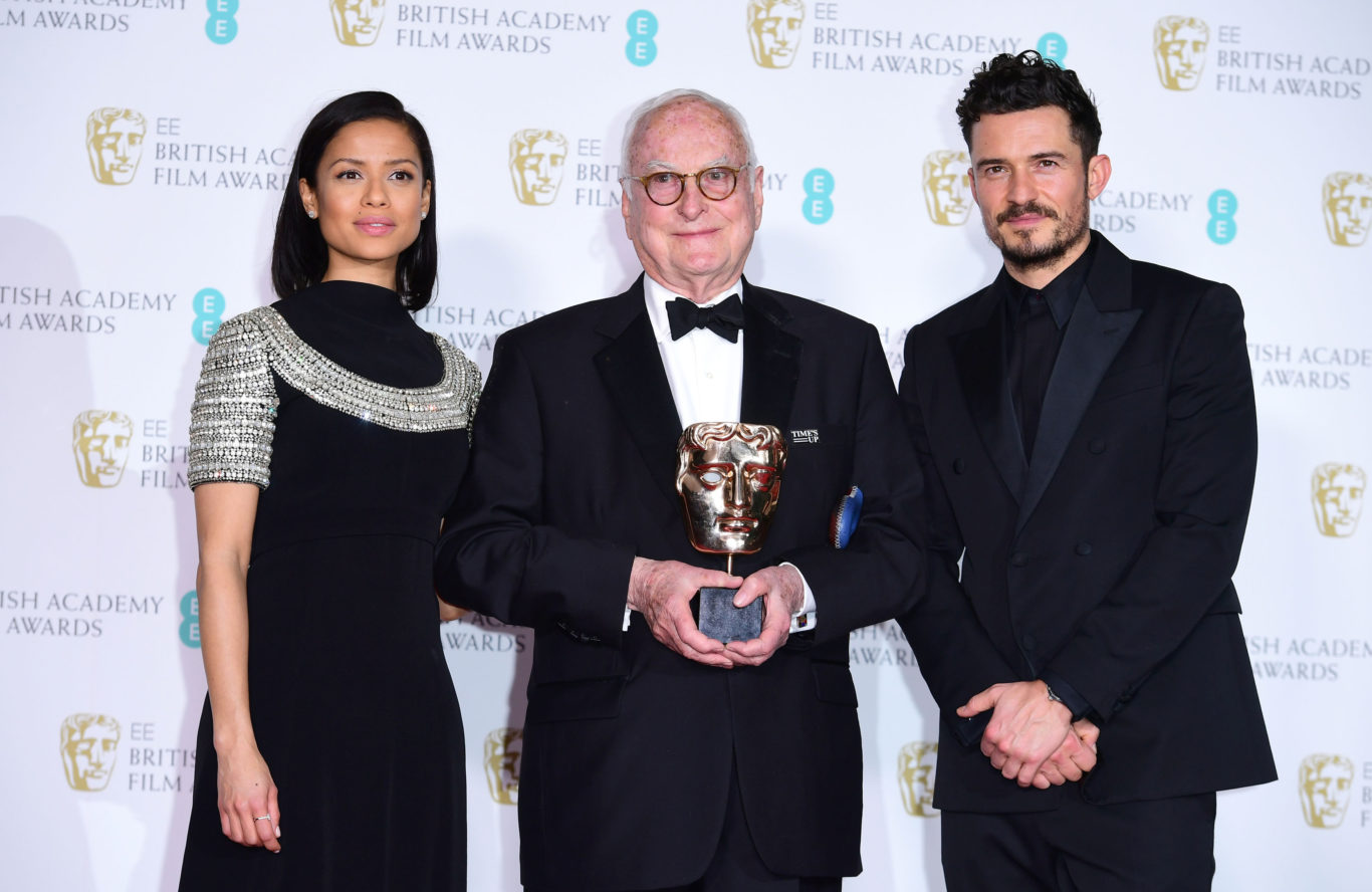 James Ivory with the Bafta for best adapted screenplay, flanked by Orlando Bloom and Gugu Mbatha-Raw (Ian West/PA)