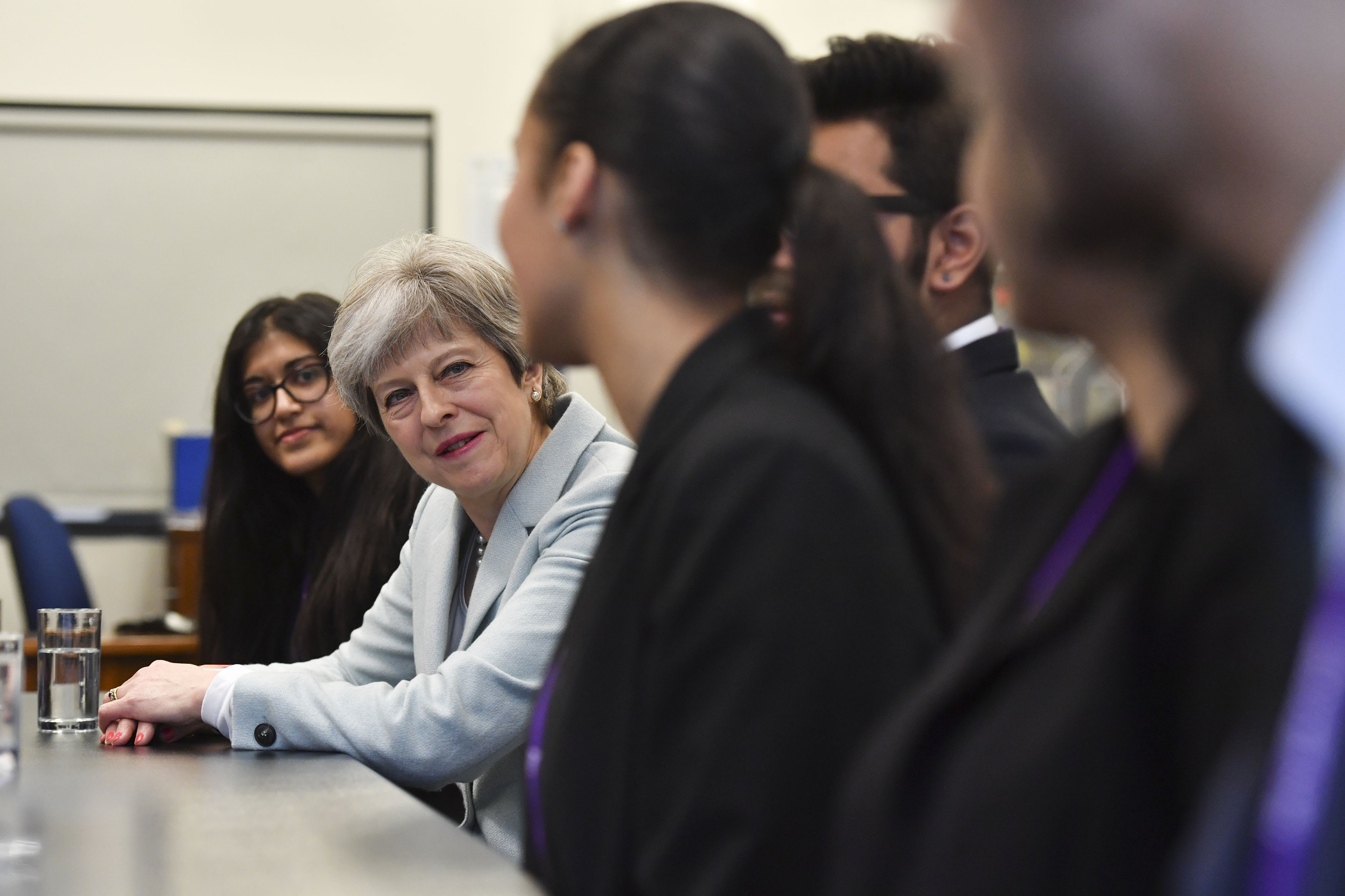 Theresa May talks with pupils and staff during a visit to Featherstone High School in west London (Ben Stansall/PA)