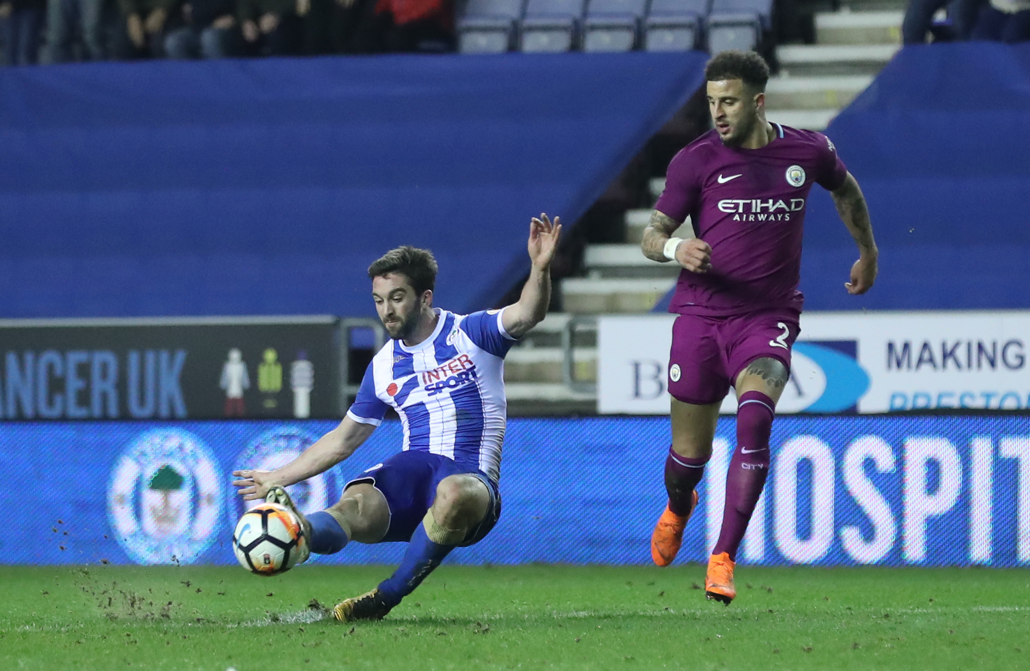 Wigan Athletic's Will Grigg (left) scores his side's first goal of the game during the Emirates FA Cup, Fifth Round match at the DW Stadium, Wigan. (Martin Rickett/PA)