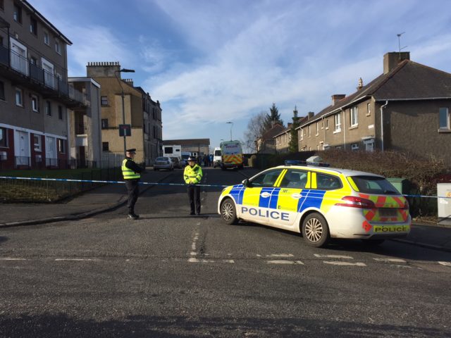 Police officers remain at the scene of the shooting in residential area of Cambuslang (Paul Ward/PA)
