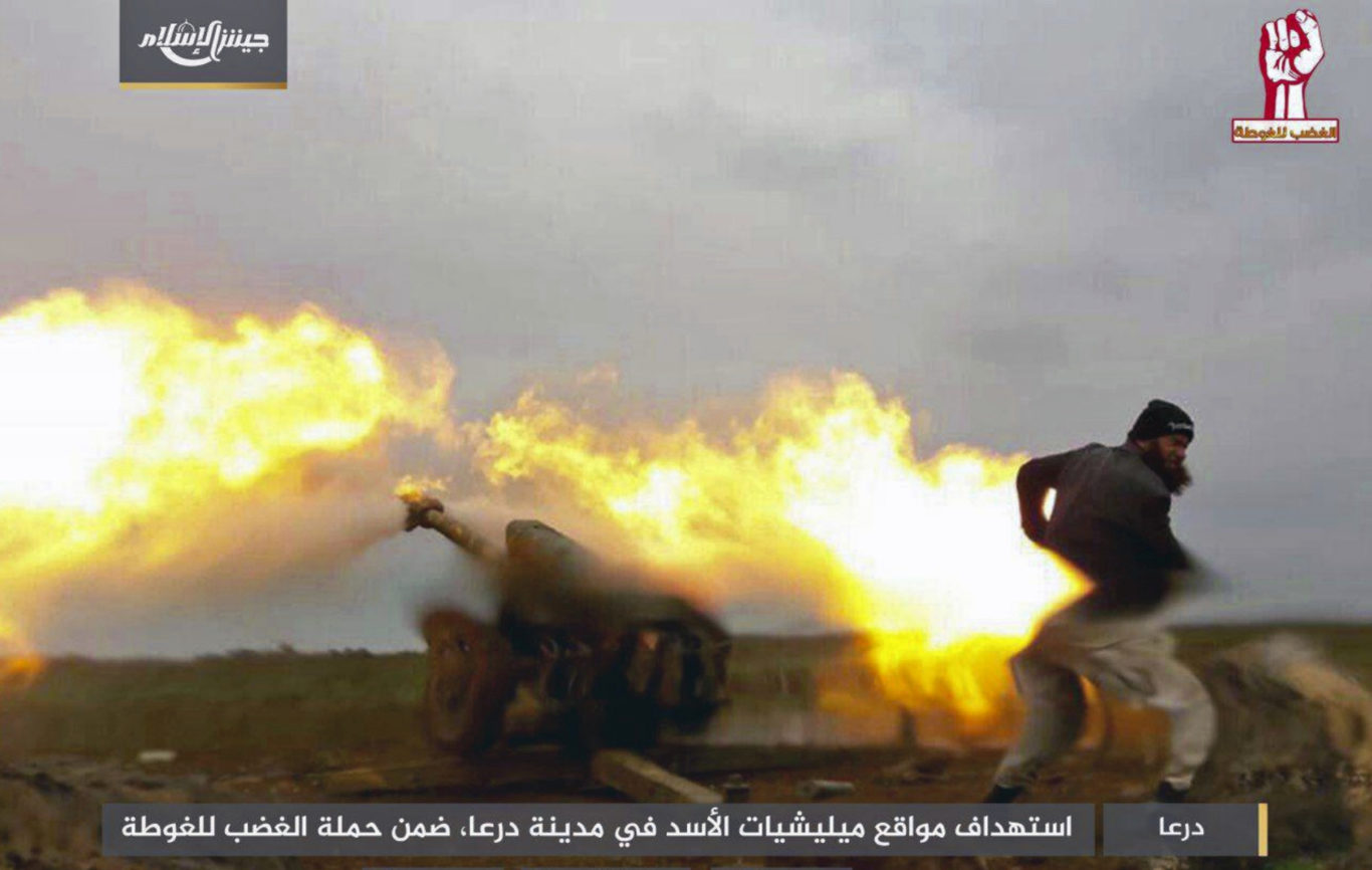 The Syrian insurgent group Army of Islam fire artillery during clashes with government forces (AP)