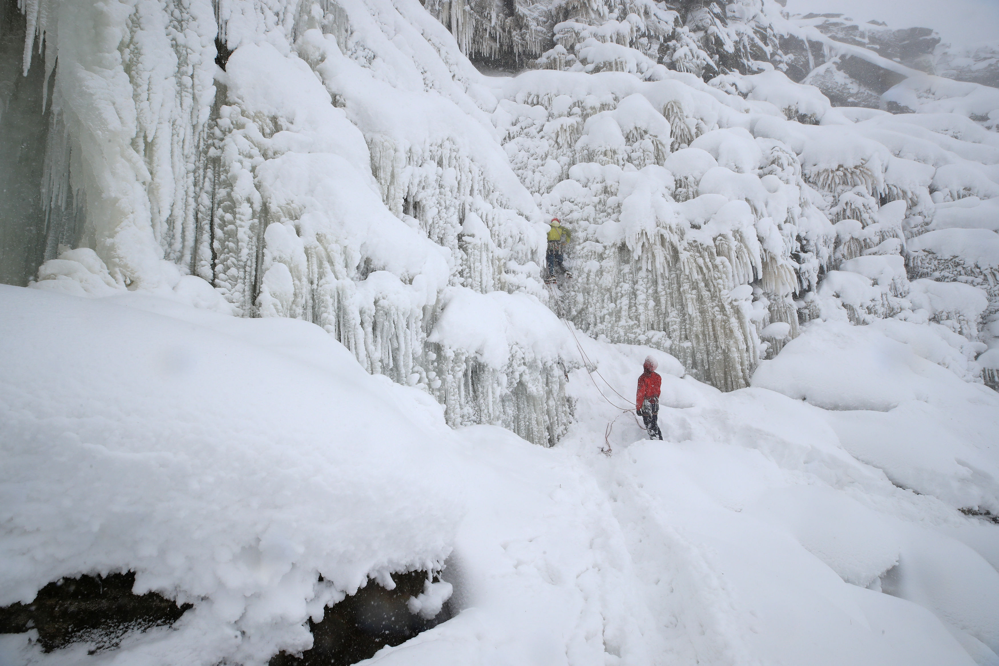 Ice climbers at Kinder Downfall, High Peak in Derbyshire