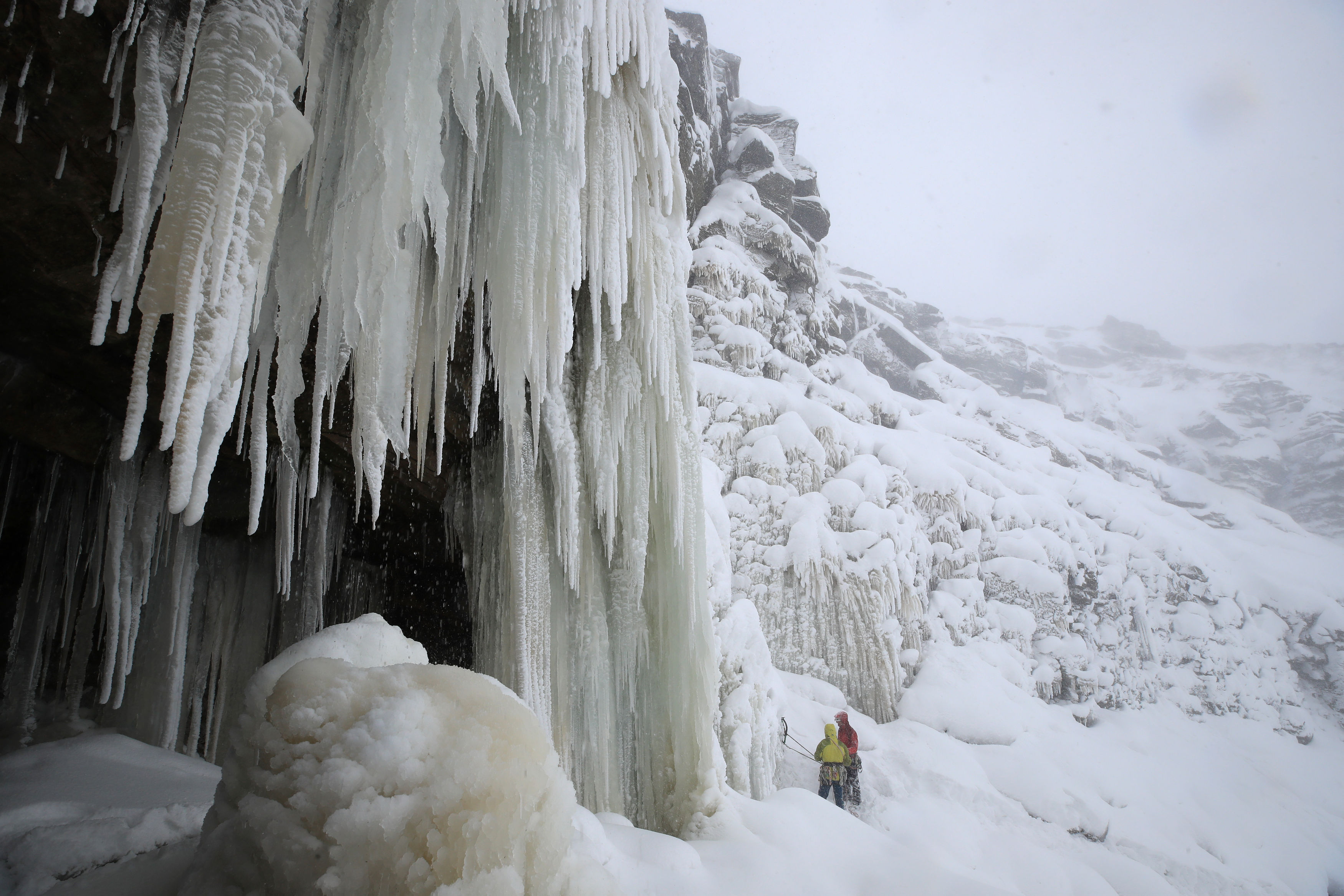 Ice climbers on the downfall at Kinder Downfall, High Peak in Derbyshire