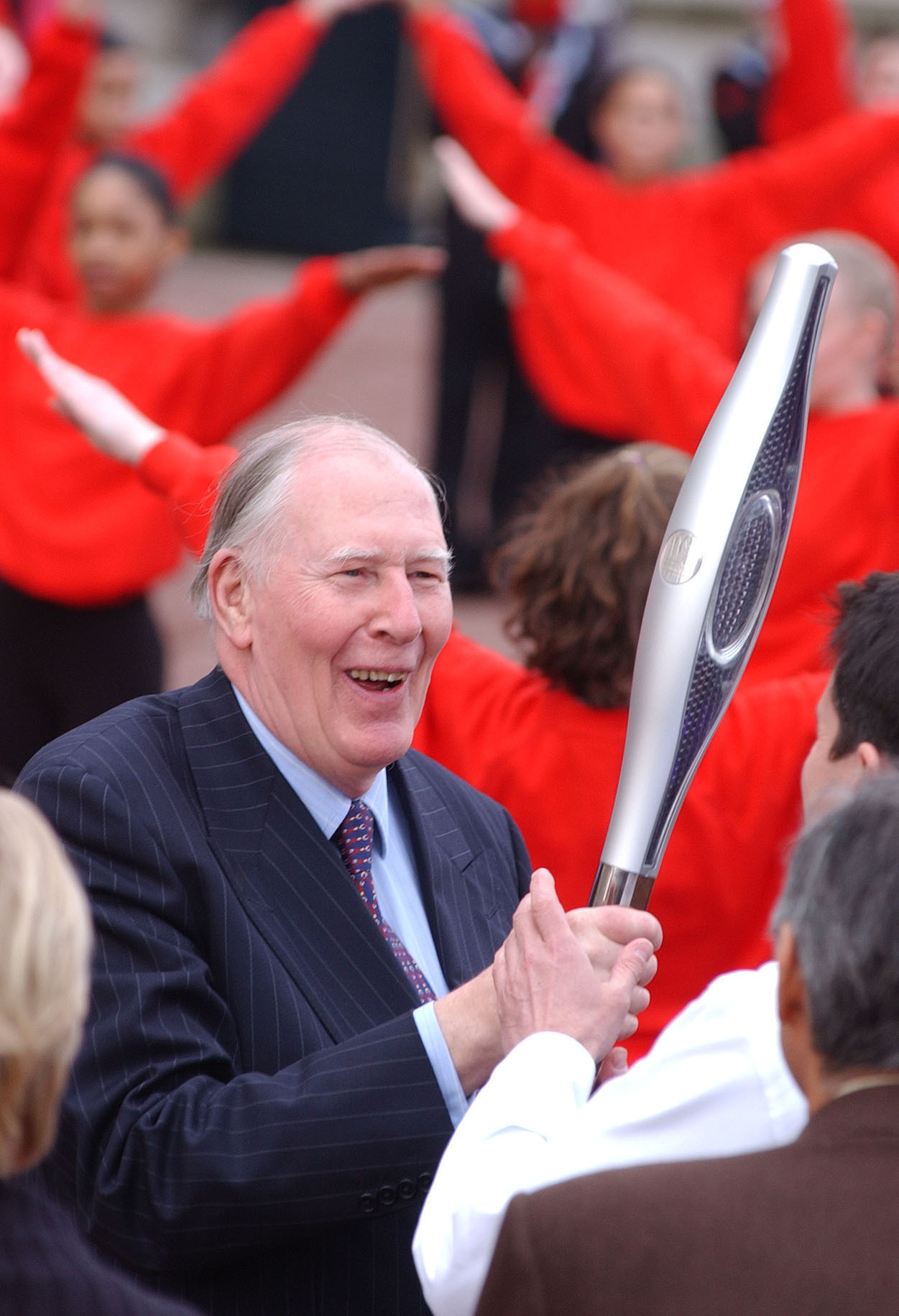 Sir Roger with the Commonwealth Games baton (PA)