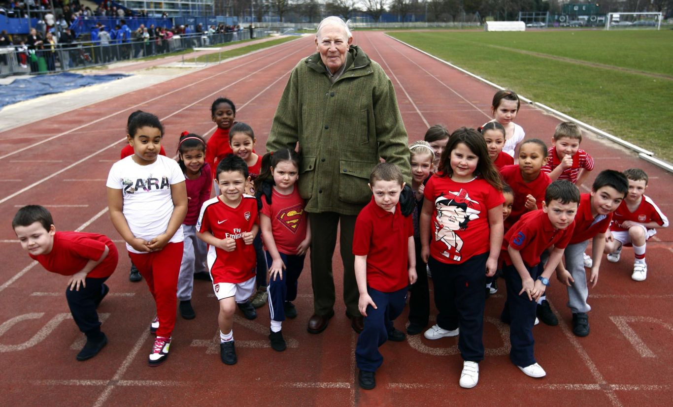 Sir Roger with children from Our Lady's school in Poplar, who were taking part in a charity running day in aid of Sport Relief (PA)
