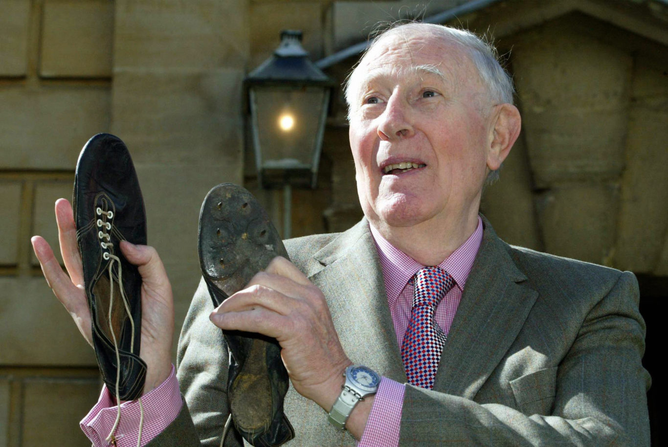 Sir Roger with his old running shoes on the 50th anniversary of the first sub-four-minute mile (Mark Lees/PA)