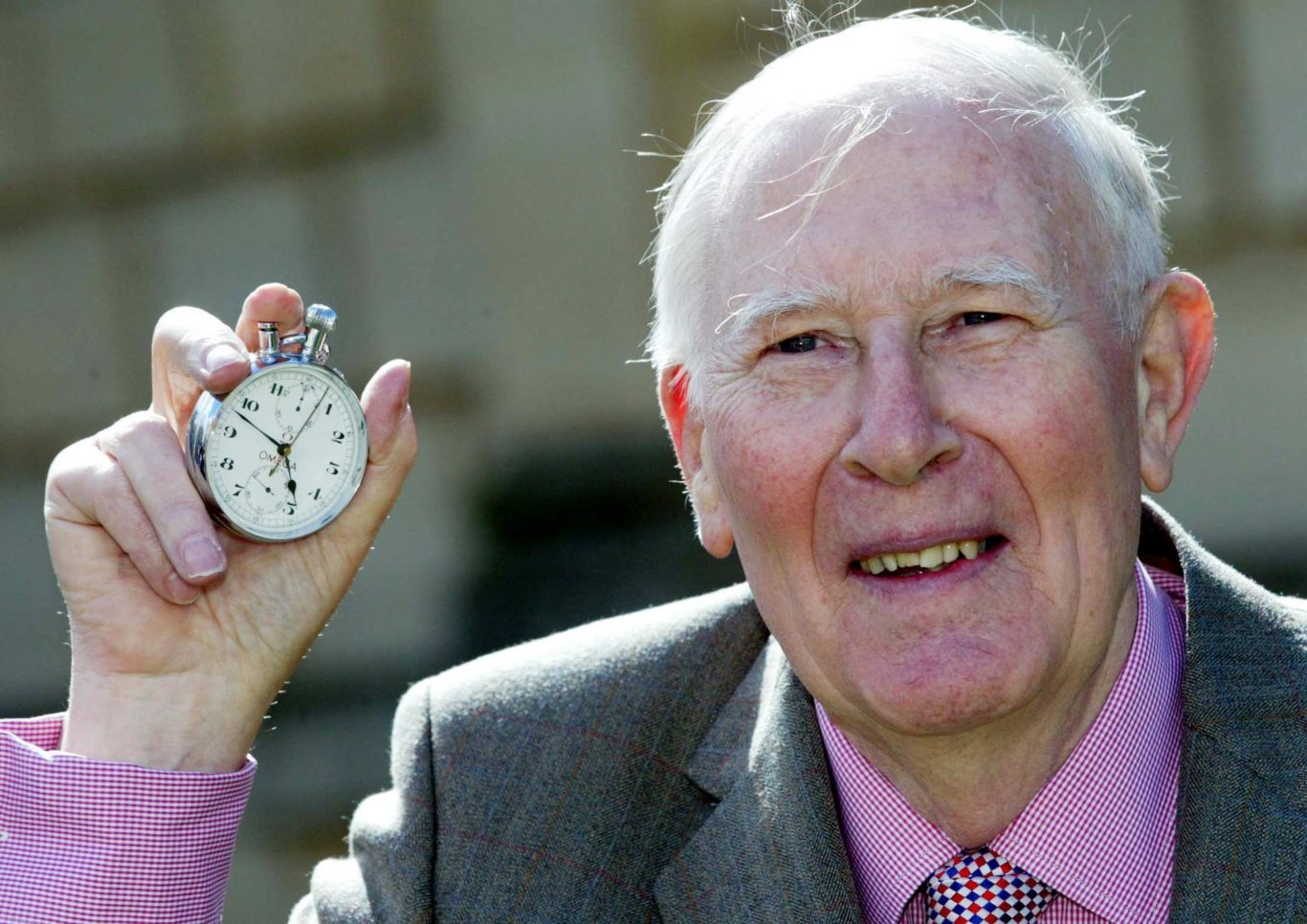 Sir Roger holds the stop-watch that recorded his sporting feat (Mark Lees/PA)