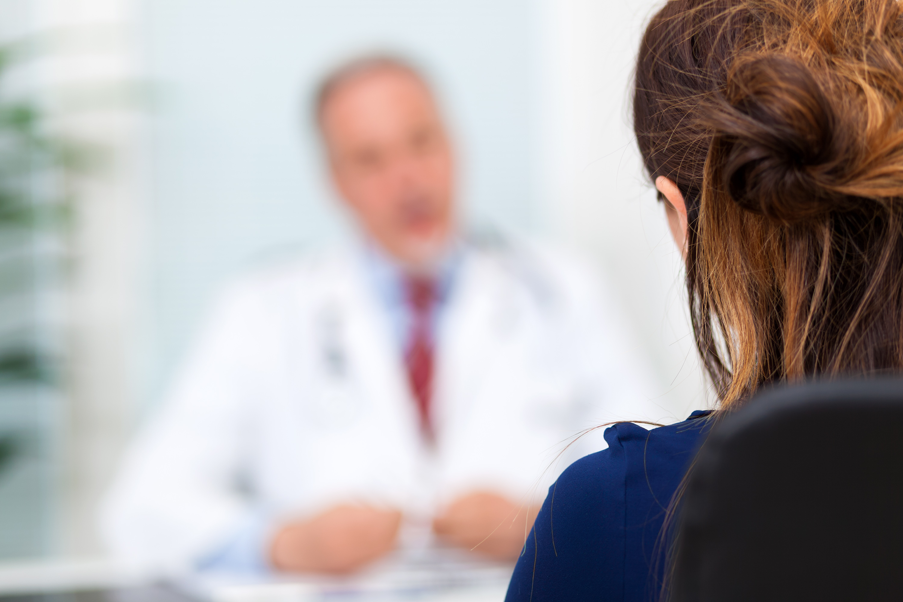 Doctor talking to a patient in his office