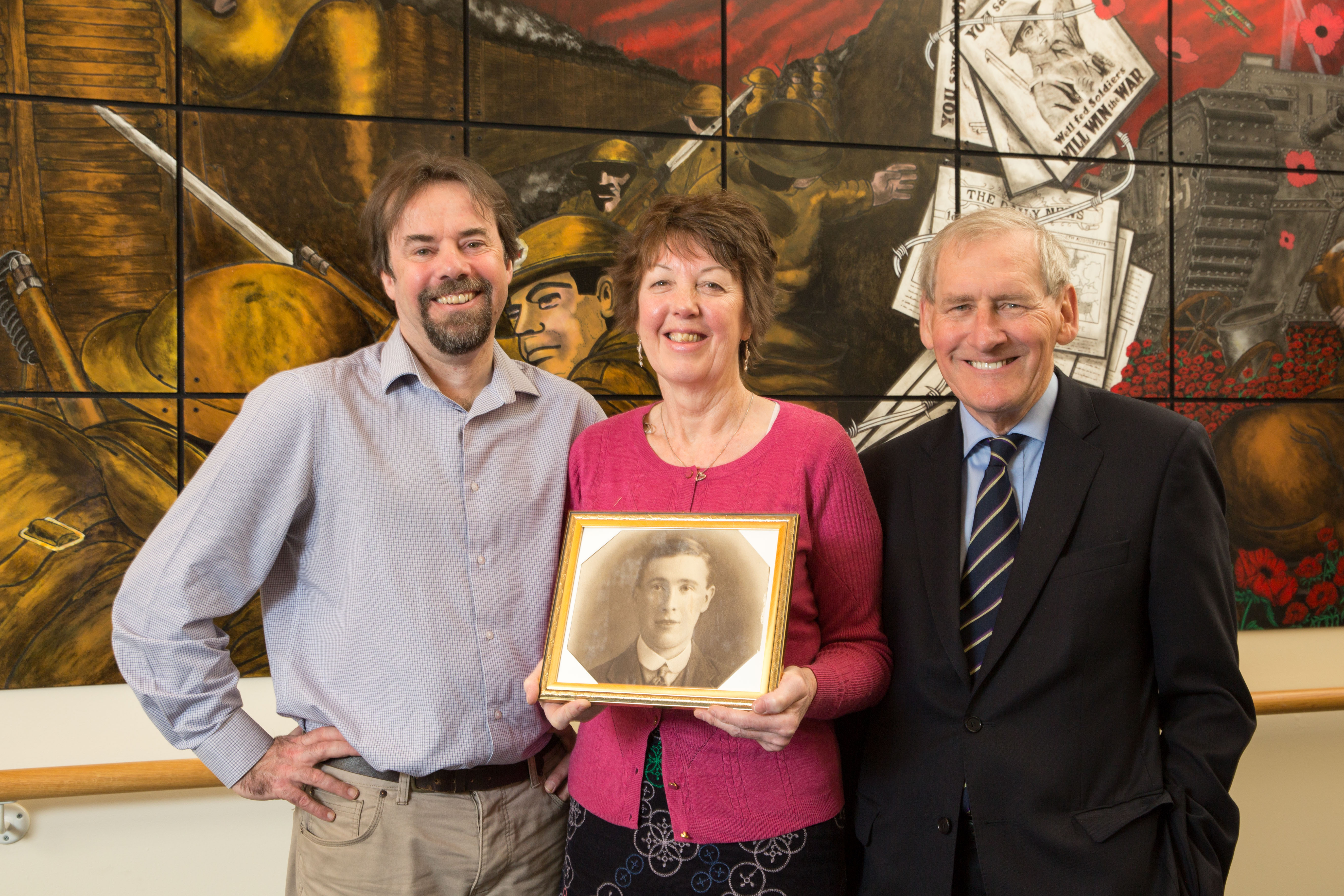 Moira Gallie (centre) holding a photo of her grandfather James Henderson with Professor Tony Pollard from Glasgow University (left) and Erskine chairman Robin Crawford (right) (Robert Perry/Erskine/PA)
