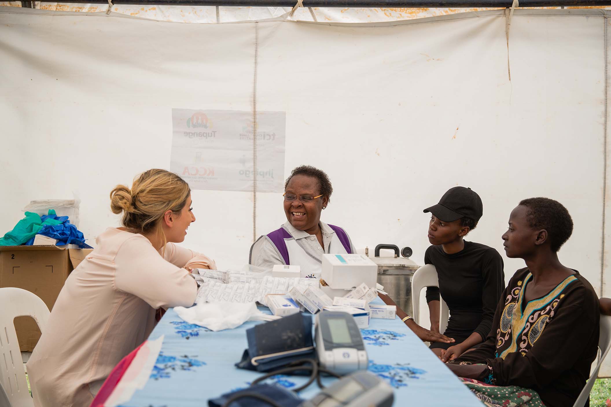 Stacey with Nubuwati's two eldest daughters receiving family planning advice (Esther Mbabazi)