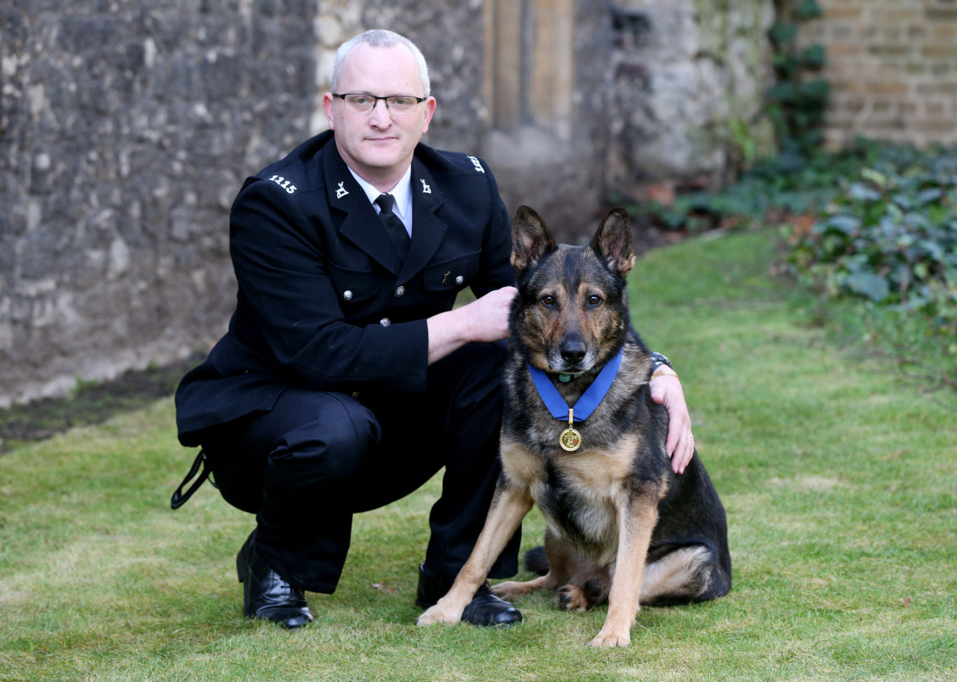 Police dog Finn, which received the PDSA Gold Medal, after being brutally stabbed in the line of duty, with his handler PC Dave Wardell, at Old Palace Yard, Westminster, London. (Jonathan Brady/PA)