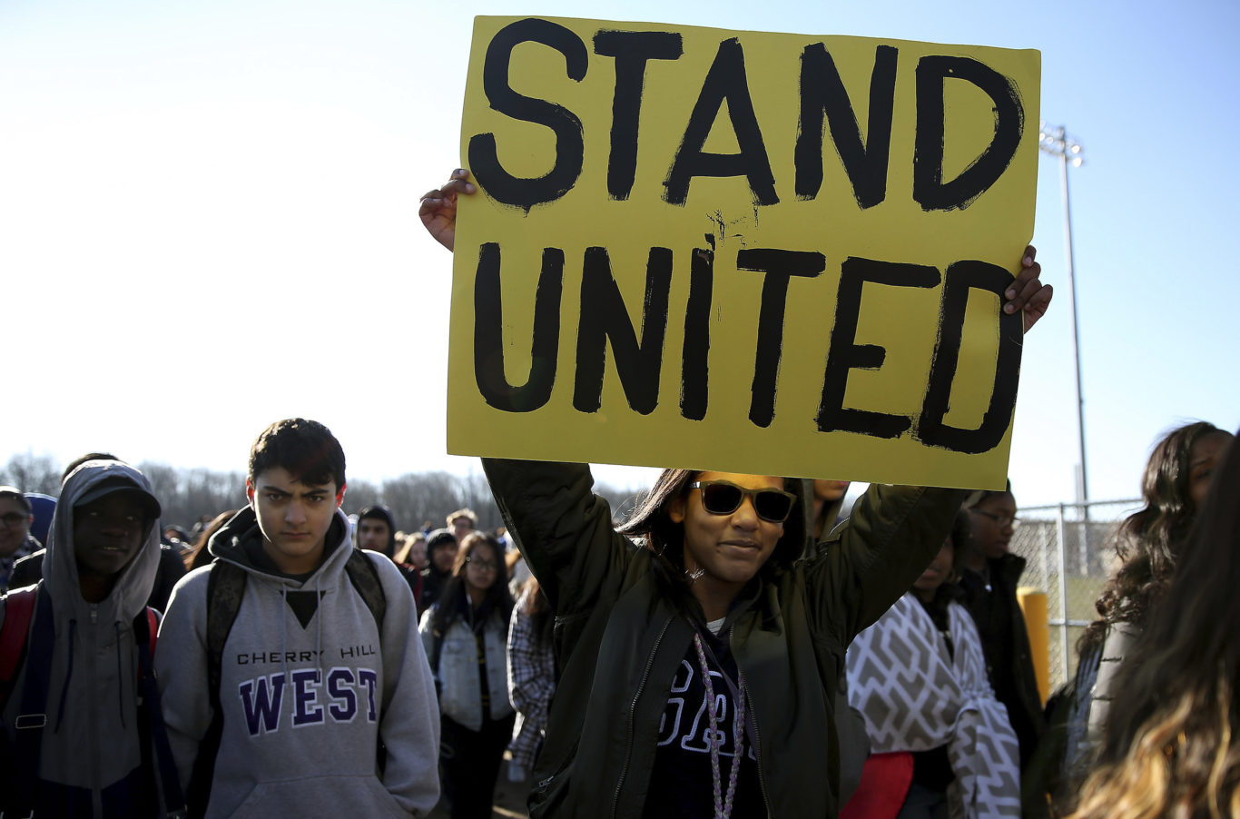 Kennedi Lawson, 14, carries a sign as student walkout at Cherry Hill West High School (David Maialetti/AP)