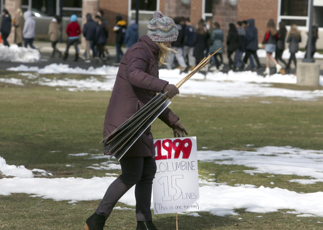 A sign commemorating the 1999 Columbine High School shooting is collected with other commemorative signs as students at Wissahickon High School in Virginia ( Jacqueline Larma/AP)