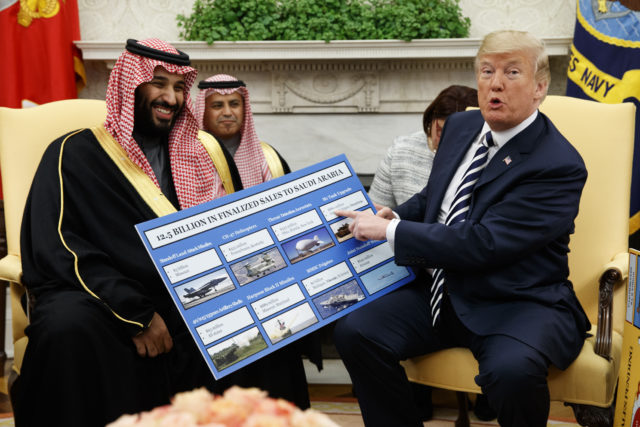 US President Donald Trump shows a chart highlighting arms sales to Saudi Arabia during a meeting with Crown Prince Mohammed bin Salman in the Oval Office (Evan Vucci/AP)