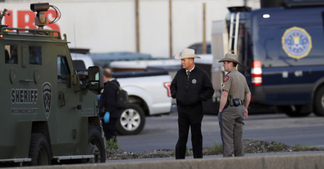 Officials investigate the scene where a suspect in a series of bombing attacks in Austin blew himself up (Eric Gay/AP)